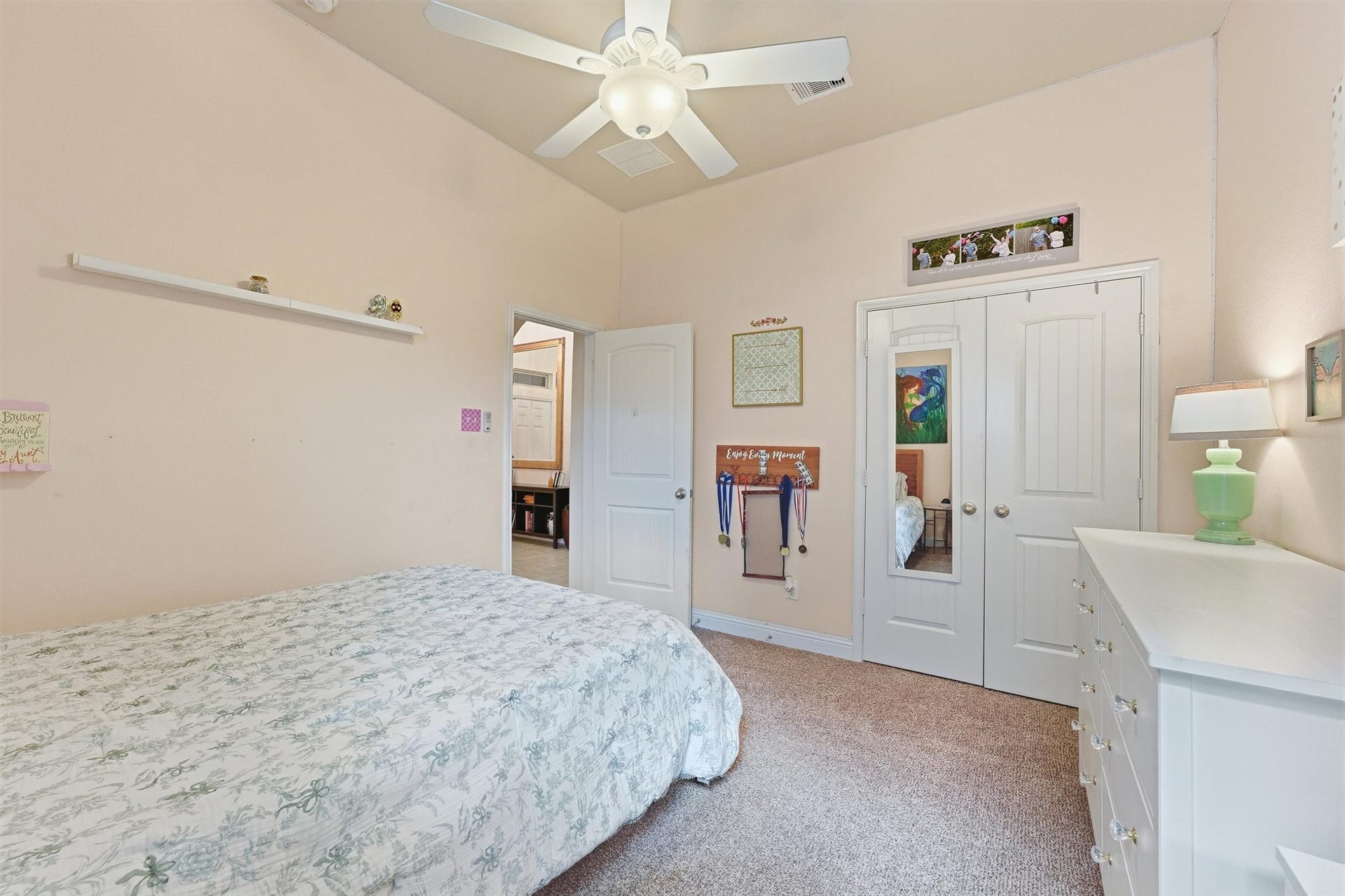 1413 Silver Rings Court, Pearland, TX 77581 Natural light streams in through a large window, enhancing the bedroom's warm and inviting atmosphere.