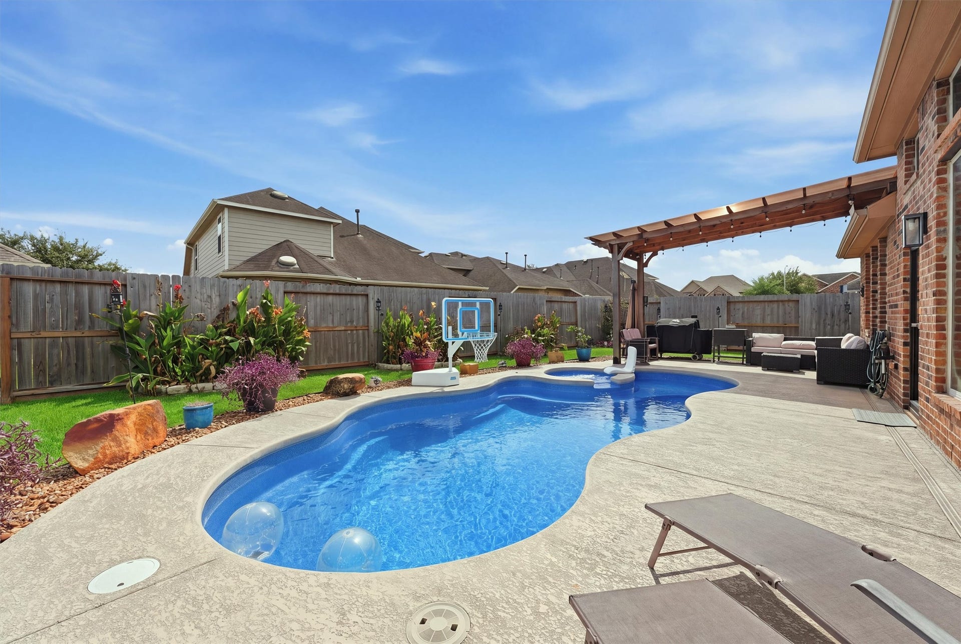 1413 Silver Rings Court, Pearland, TX 77581 Enjoy a private oasis with this beautifully landscaped backyard featuring a sparkling pool, spacious patio with pergola, and plenty of room for outdoor relaxation and entertaining.