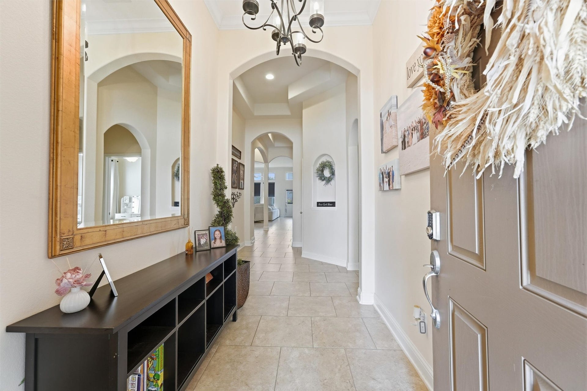 1413 Silver Rings Court, Pearland, TX 77581 Inviting entryway with elegant arches, chic tile flooring, and a welcoming decor, leading to spacious living areas.