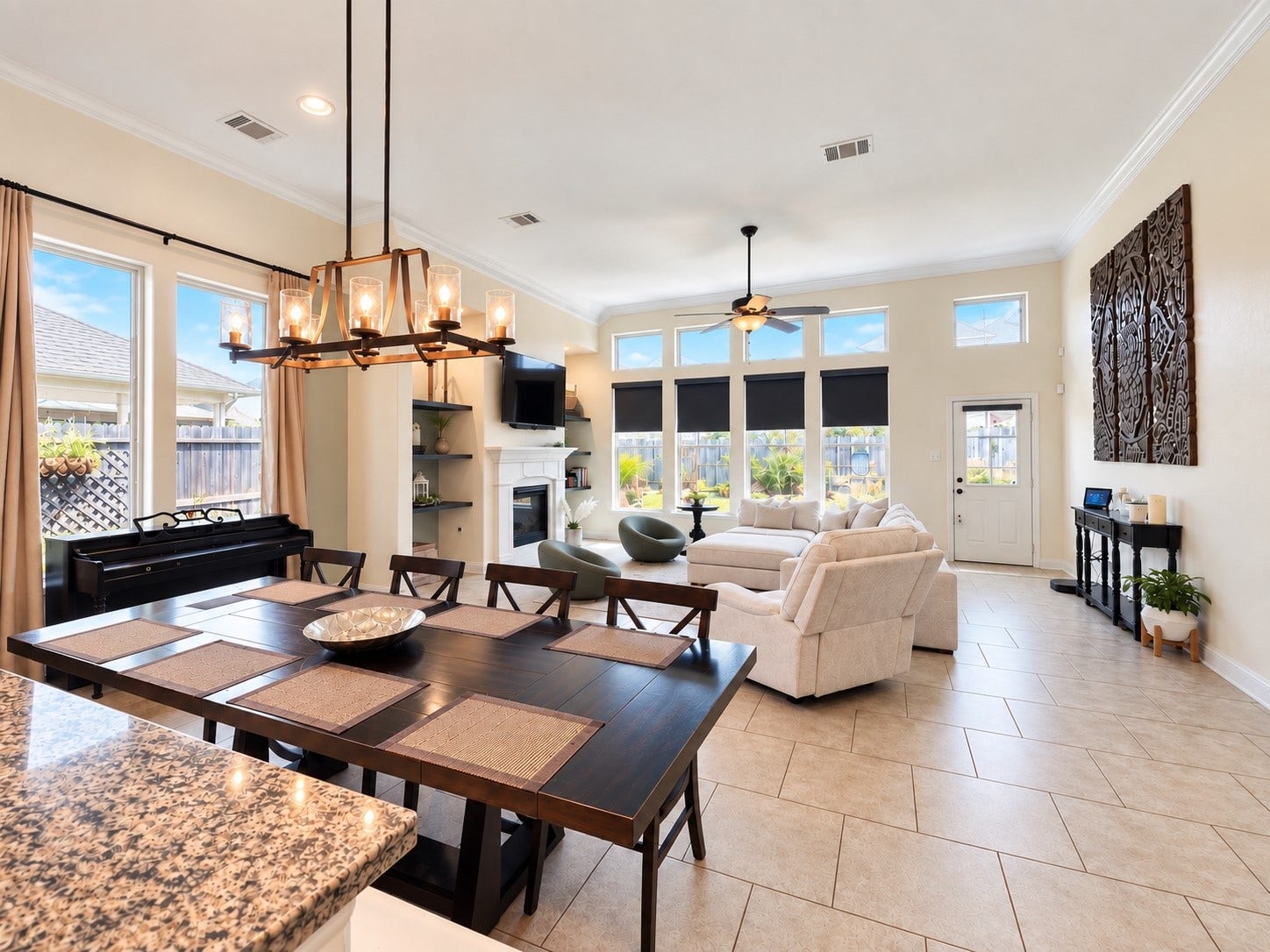 1413 Silver Rings Court, Pearland, TX 77581 Spacious open-concept living area with high ceilings, abundant natural light, and elegant tile flooring, featuring a cozy fireplace and modern lighting fixtures.
