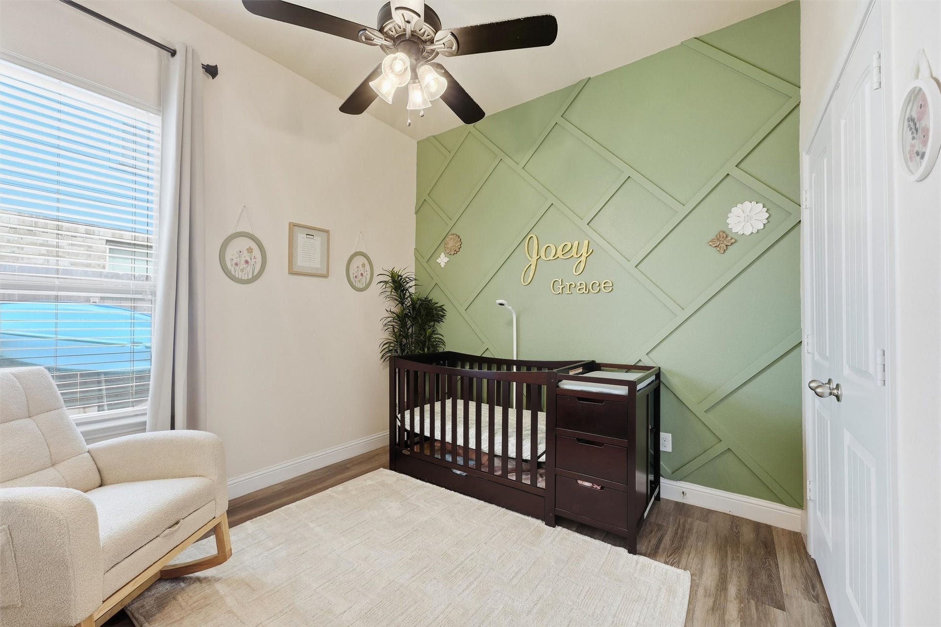 1413 Silver Rings Court, Pearland, TX 77581 Charming bedroom #4 featuring a sage green accent wall with geometric detailing complemented by natural light from a large window.