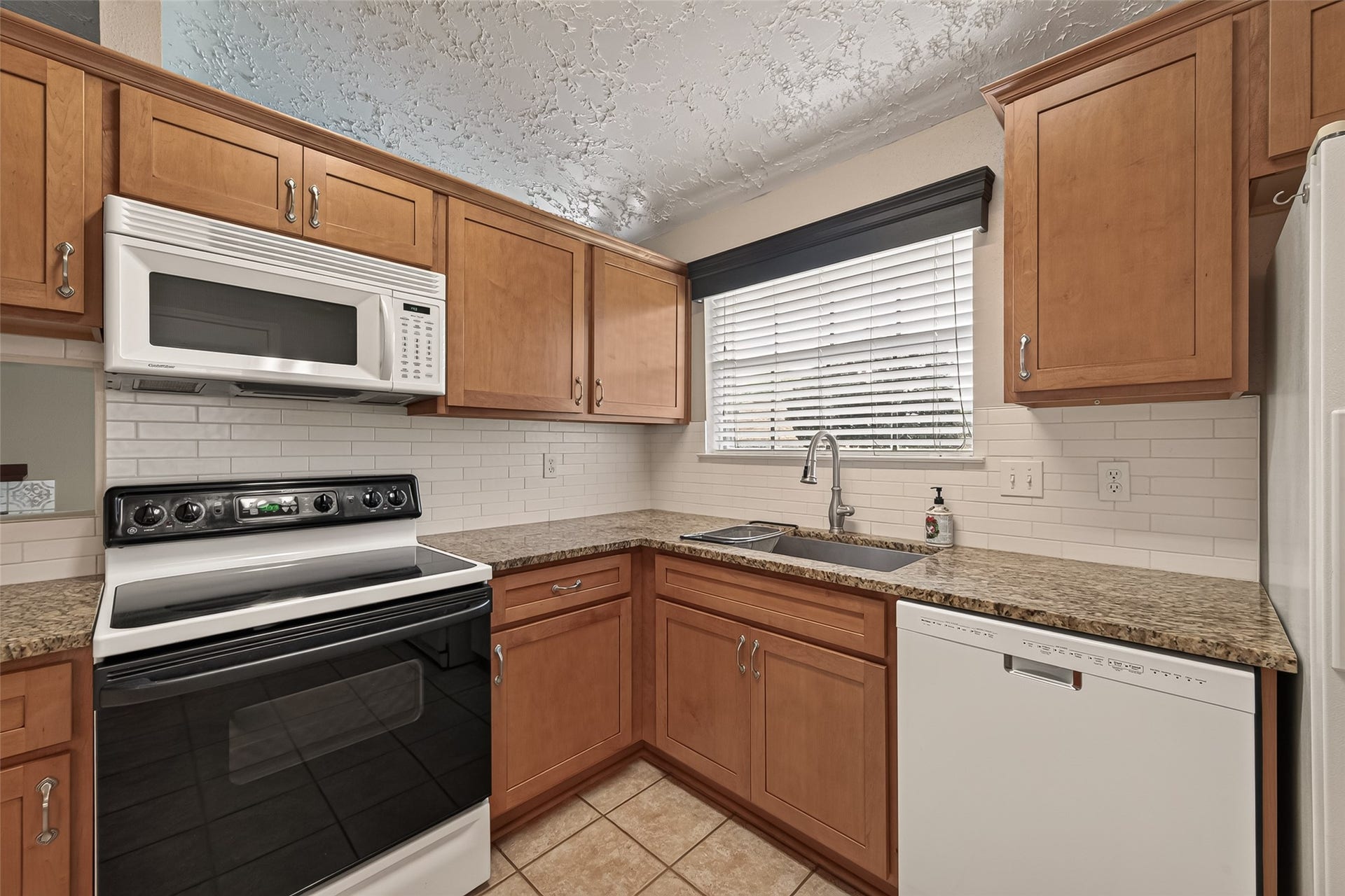 2811 Pheasant Creek Drive, Sugar Land, TX 77498 Another kitchen view showcasing the sink, dishwasher, cabinetry and natural light.