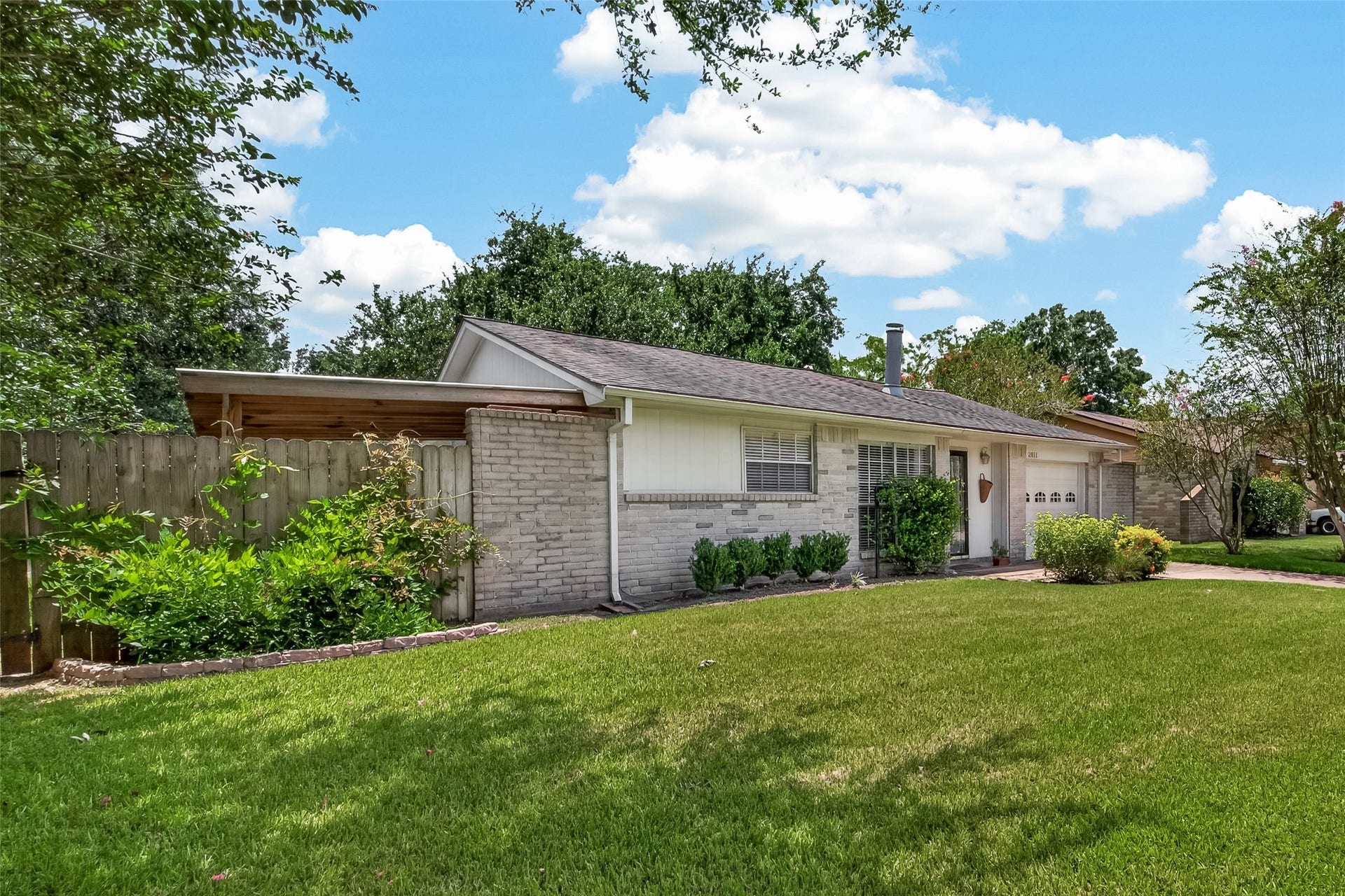 2811 Pheasant Creek Drive, Sugar Land, TX 77498 Alternate exterior view showcasing the single-story design and front lawn.