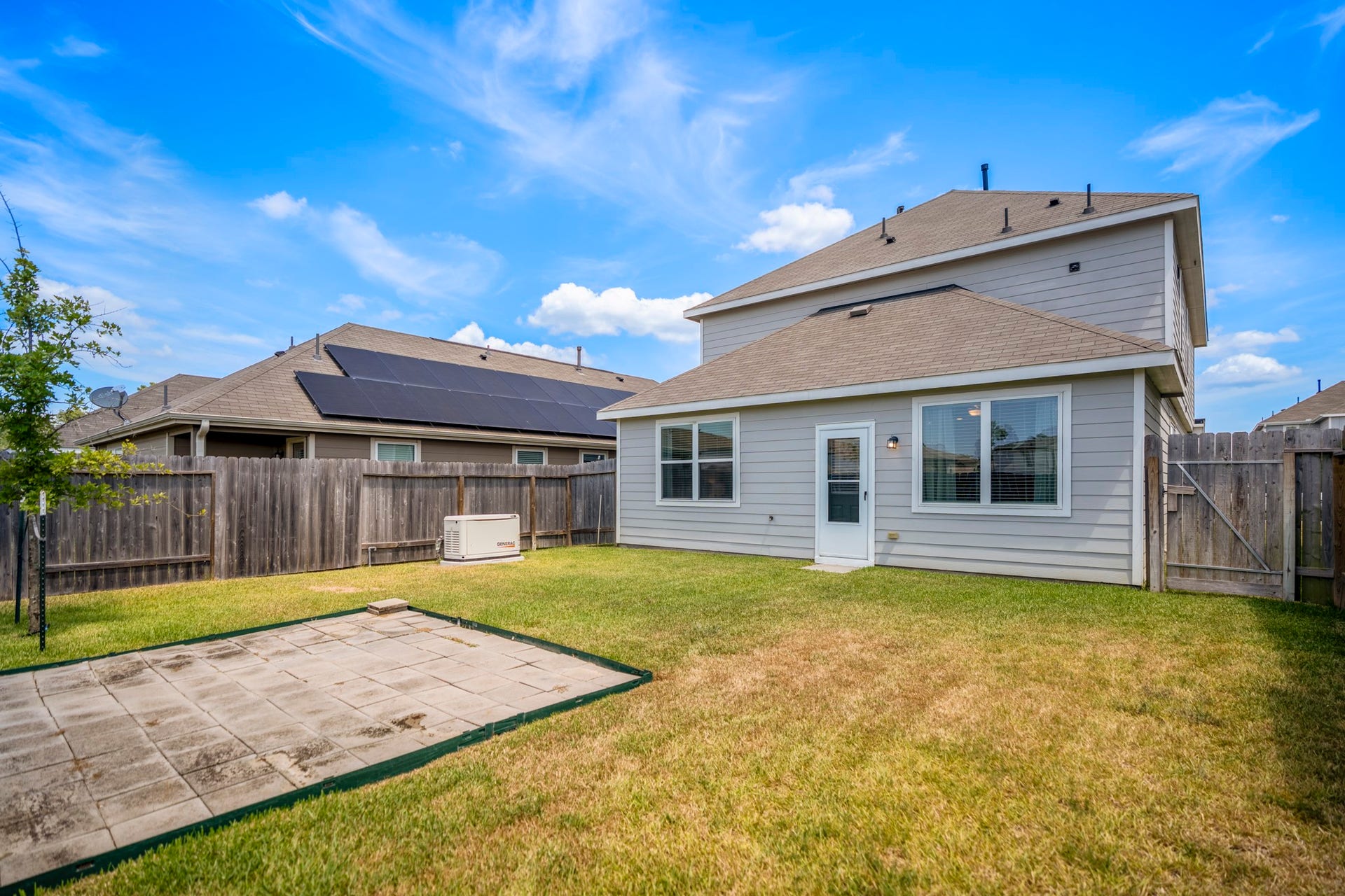 2355 Mount Locke Path, Conroe, TX 77301 Heading outside, the backyard opens up with a manageable lawn, concrete patio space and a full view of the homes rear elevation.