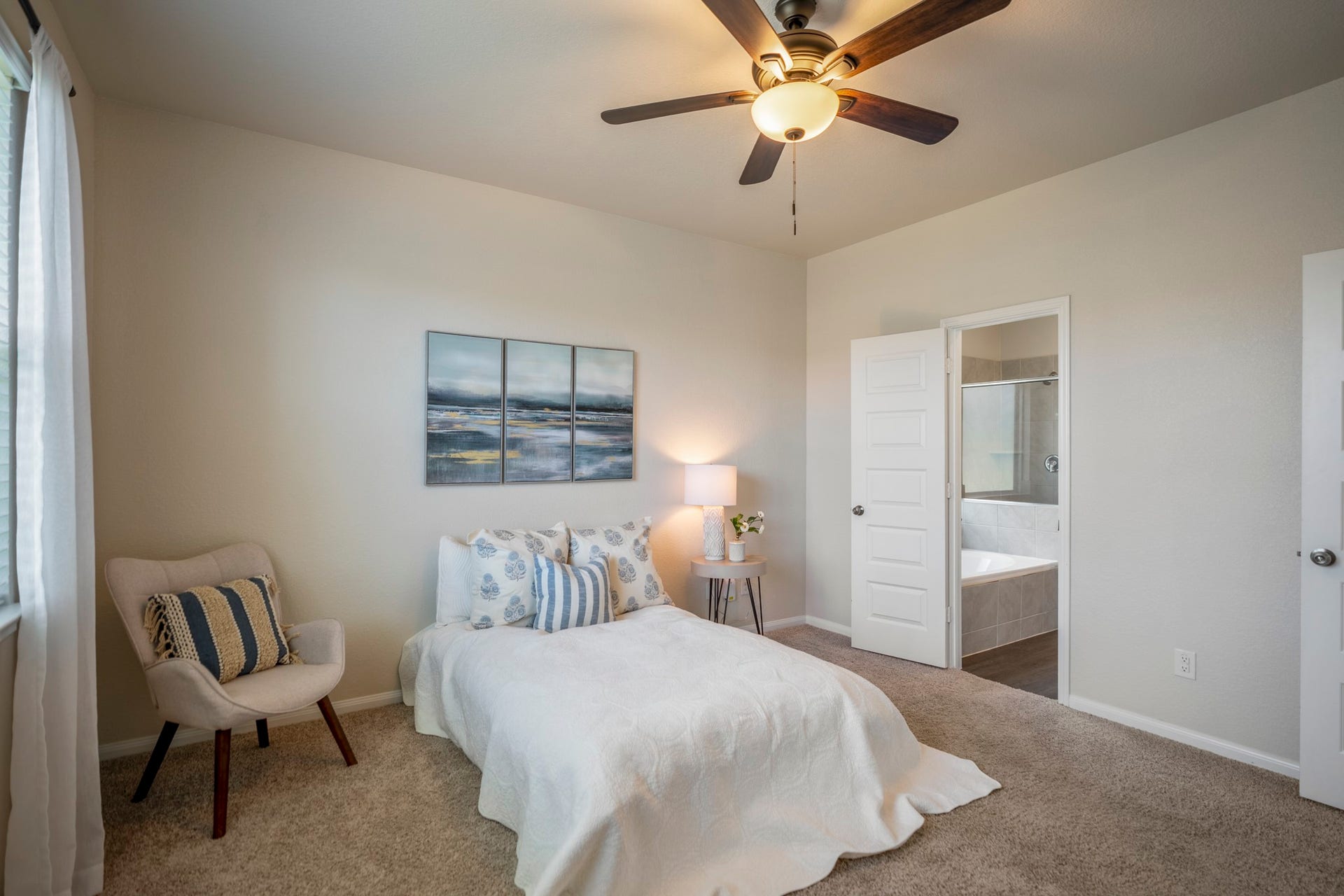 2355 Mount Locke Path, Conroe, TX 77301 A second angle of the primary suite shows the rooms natural light from the side window and the easy path into the bath through the open doorway ahead.