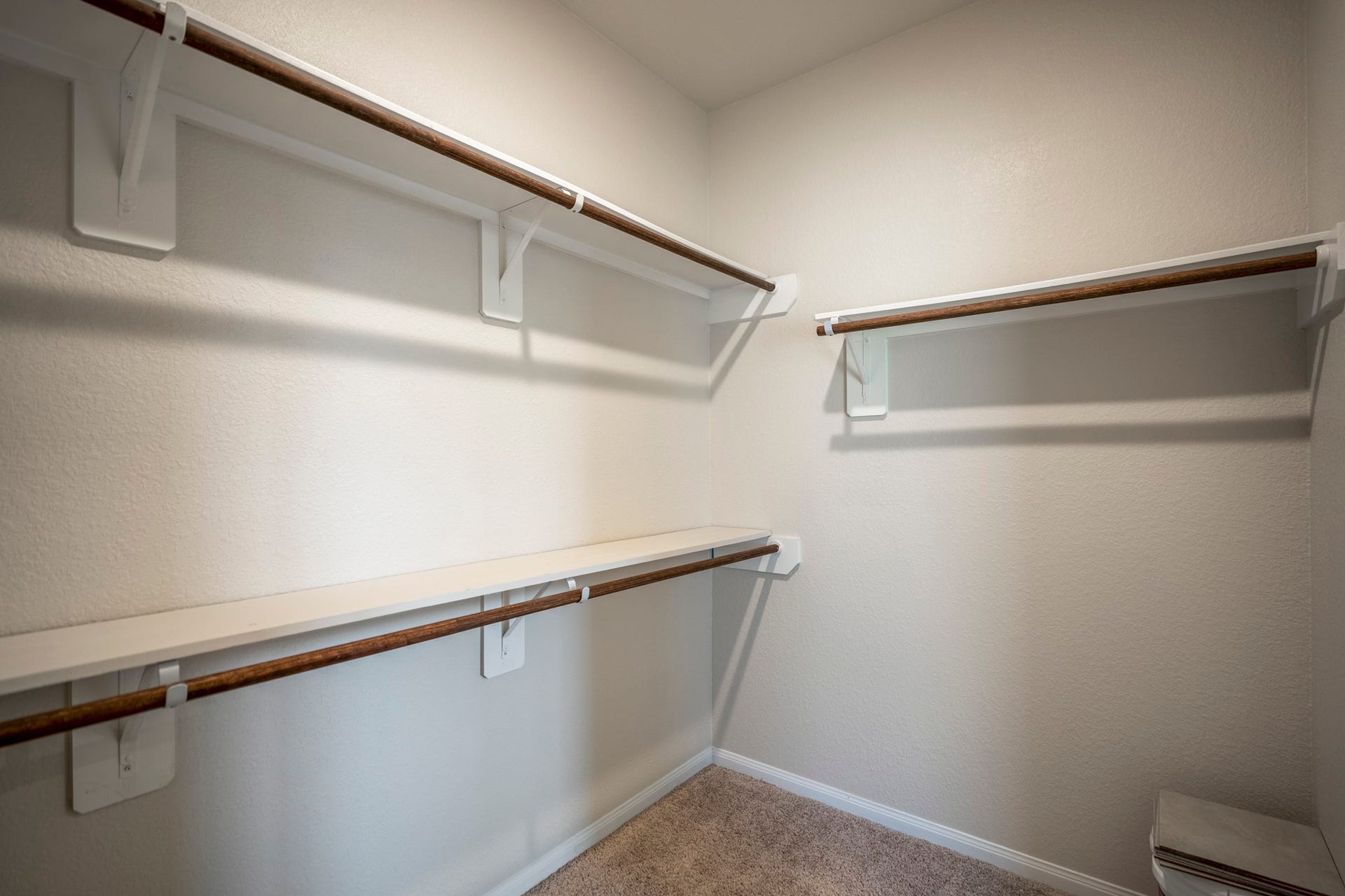 2355 Mount Locke Path, Conroe, TX 77301 Stepping into the primary walk-in closet, the storage really delivers with an impressive amount of hanging space and built-in shelving wrapping around the room. Its size is a standout feature of the suite, with the primary bath just outside the doorway for an easy everyday routine.