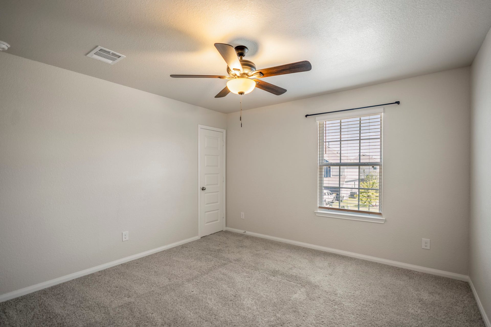 2355 Mount Locke Path, Conroe, TX 77301 Stepping through the doorway off the gameroom brings you into the second bedroom, where a window adds natural light and a ceiling fan sits overhead. The room continues the upstairs layout with plenty of space to settle in, and one of the homes notably large bedroom closets adds valuable storage just beyond.