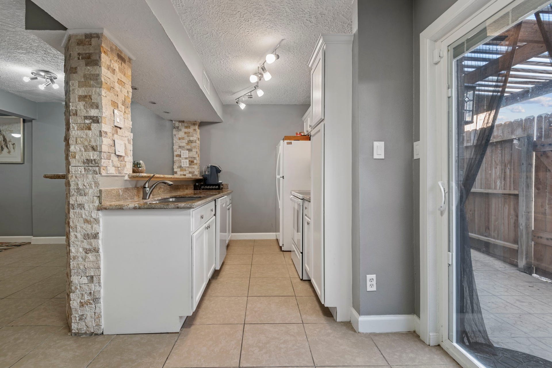 The kitchen features granite countertops, recently installed dishwasher, electric cooktop and stove, microwave, and fridge.