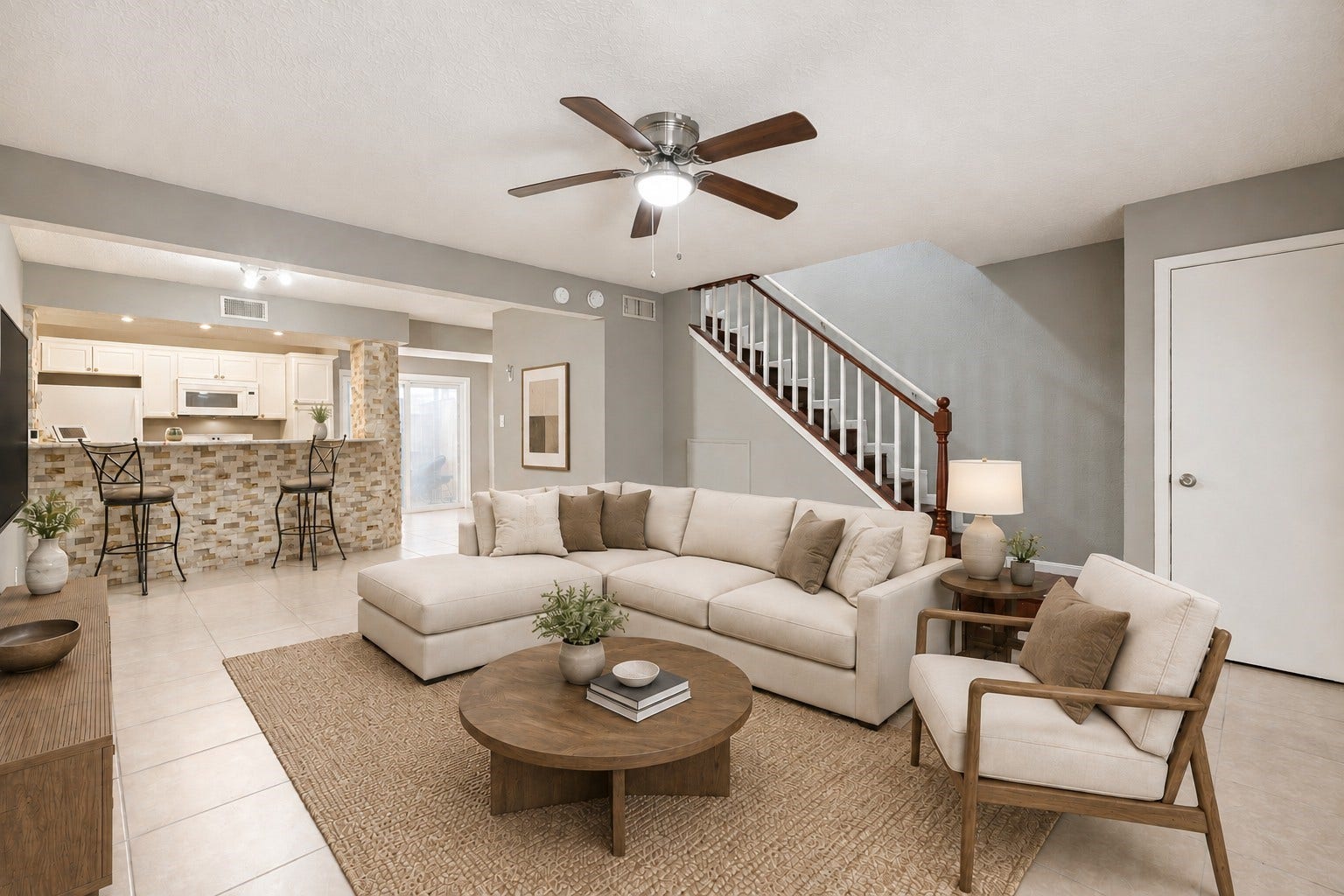 Welcome to Unit 50 in the Beverly Village Townhome community! The spacious living room is open to the dining area and kitchen and features modern finishes.