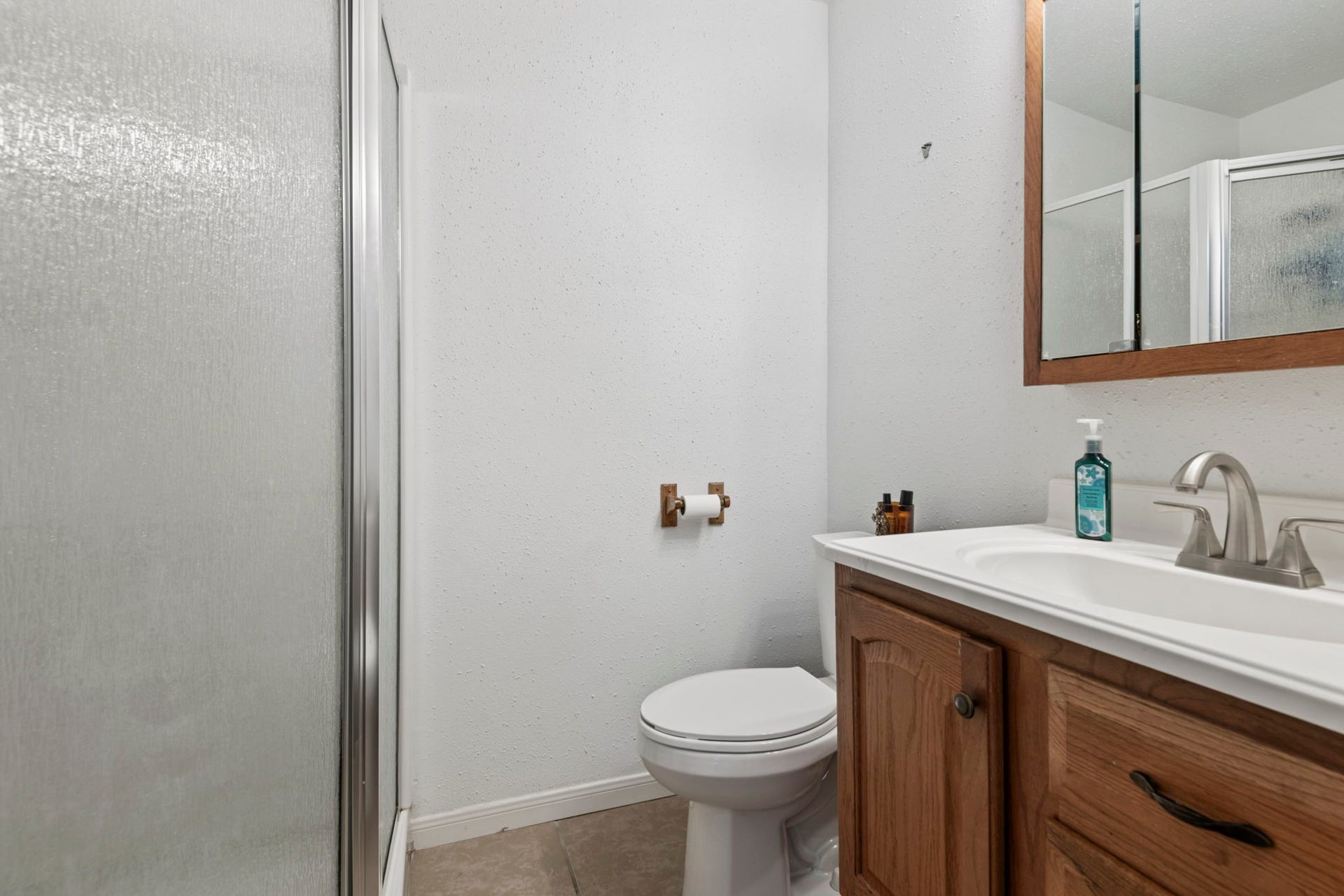The bathroom attached to bedroom 2 with shower.