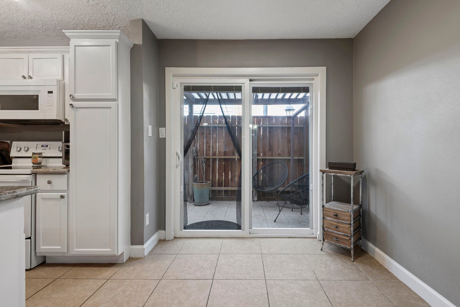 The breakfast room leads to the fenced in private porch area.