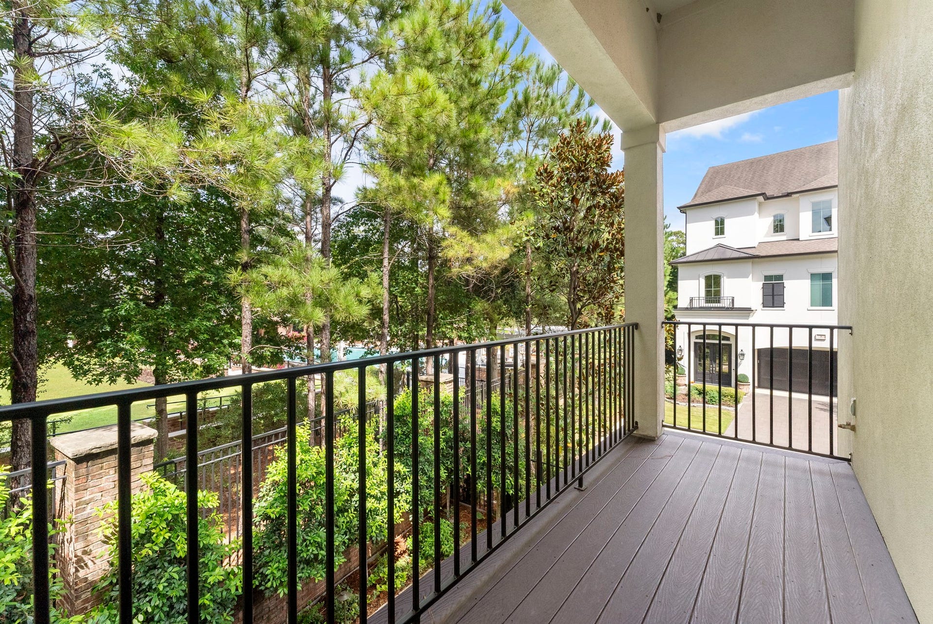 10 Nautical Terrace Way, The Woodlands, TX 77380 Covered balcony with low-maintenance composite decking overlooking mature pines, offering year-round shade and true privacy with no rear neighbors.
