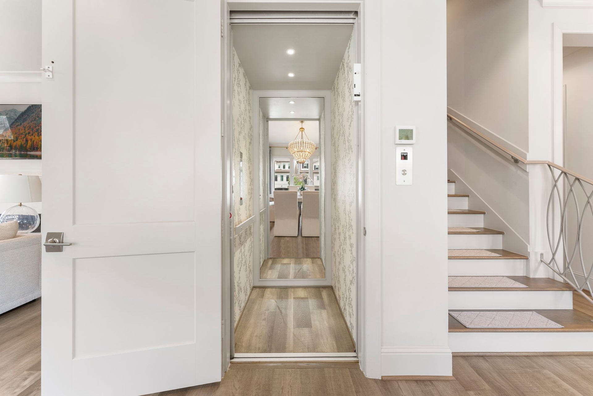 10 Nautical Terrace Way, The Woodlands, TX 77380 Private residential elevator serving all four floors, finished in designer wallpaper, a coveted convenience in luxury townhome living.