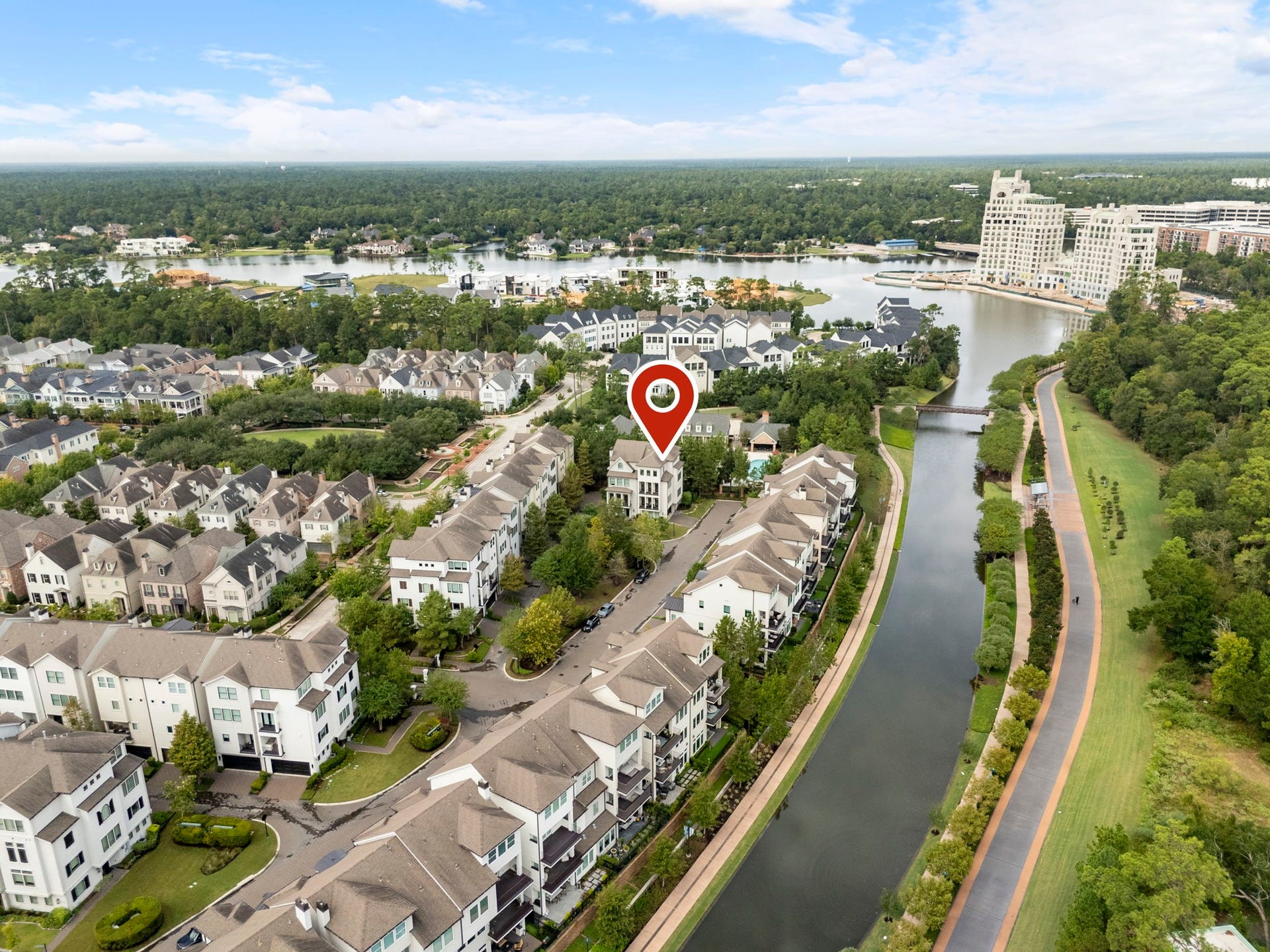 10 Nautical Terrace Way, The Woodlands, TX 77380 Bird's-eye view showcasing this end-unit residence within Waterway Landing, near the community pool, the scenic Waterway and its landscaped walking paths, with Lake Woodlands and Town Center just beyond.