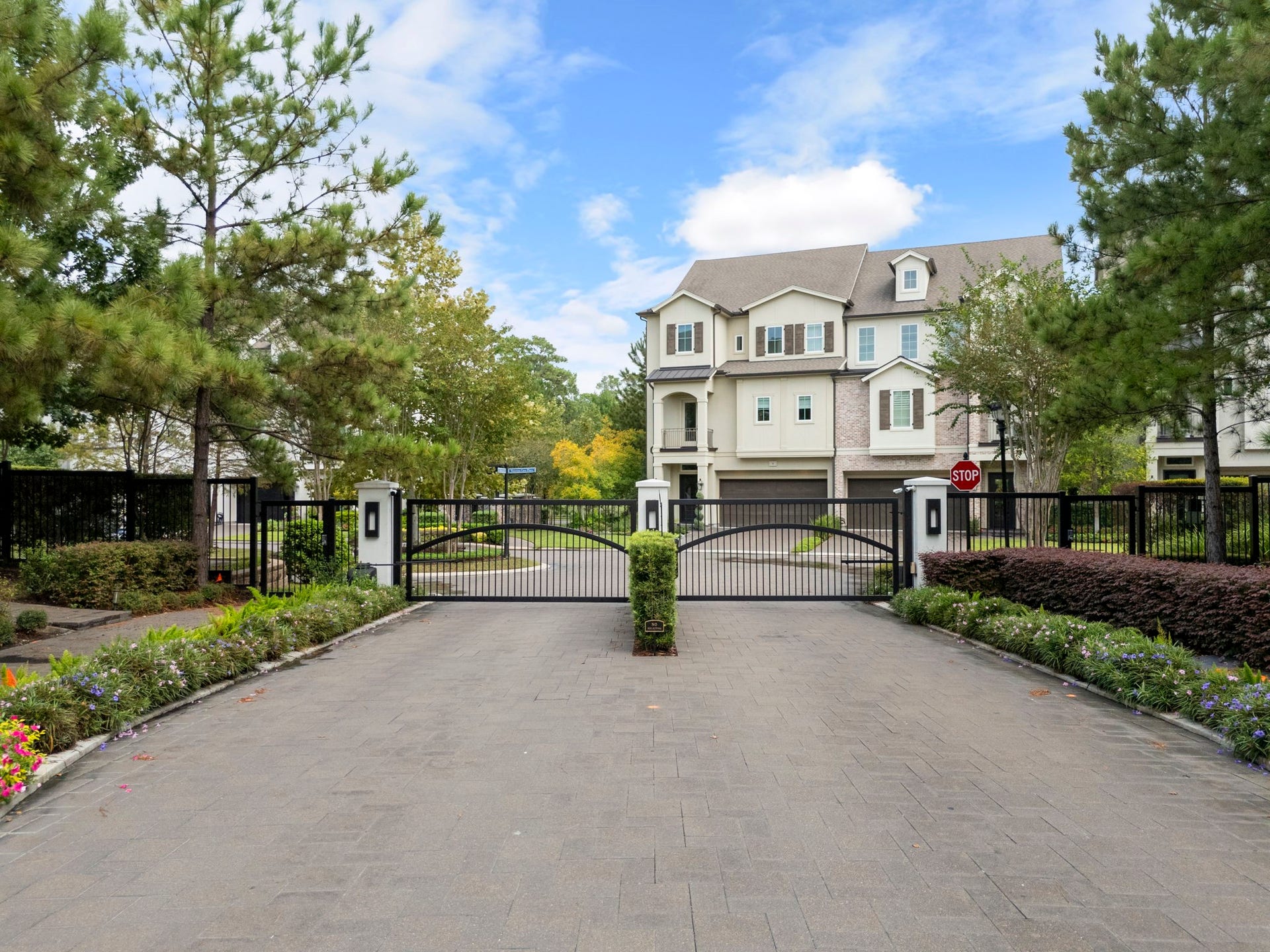10 Nautical Terrace Way, The Woodlands, TX 77380 Secure gated entrance to Waterway Landing, with an elegant paver approach, illuminated stone pillars and lush seasonal landscaping, an exclusive East Shore enclave minutes from Town Center.