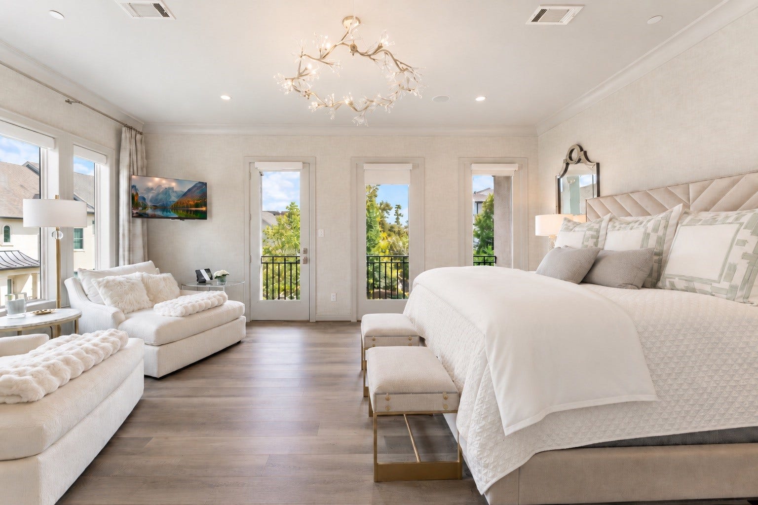 10 Nautical Terrace Way, The Woodlands, TX 77380 Expansive owner's suite showcasing three French doors framing treetop views, oversized windows, and custom window treatments.