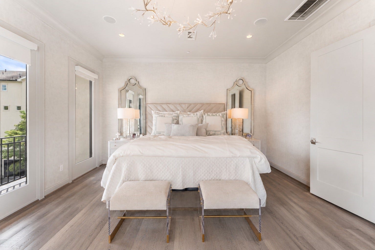 10 Nautical Terrace Way, The Woodlands, TX 77380 Serene primary retreat wrapped in luminous designer wallcovering, crowned by a sculptural branch chandelier, with direct access to a private balcony.
