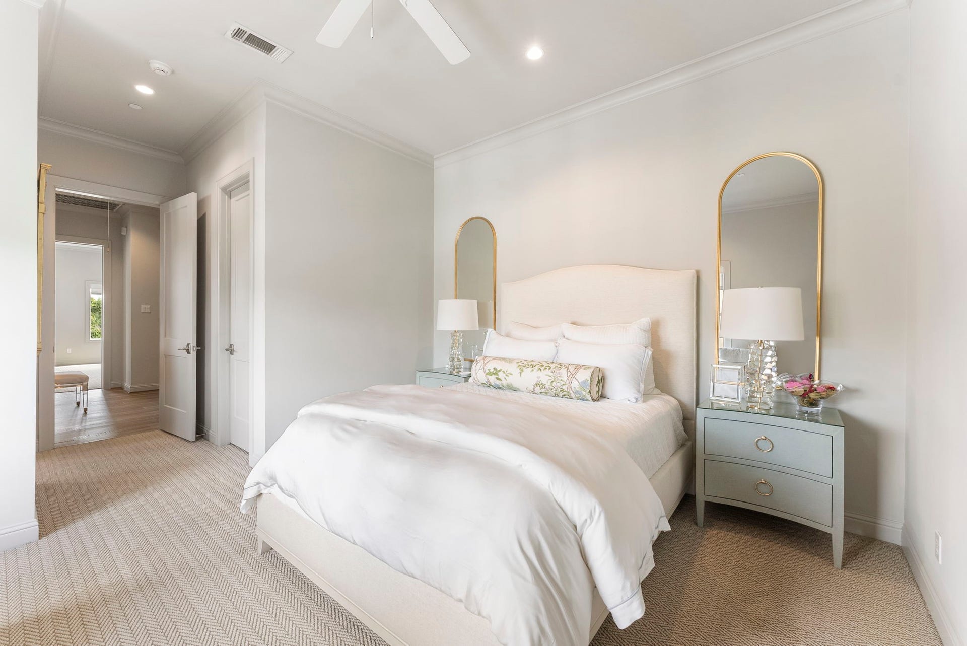 10 Nautical Terrace Way, The Woodlands, TX 77380 Second fourth-floor bedroom with a generous closet, plush patterned carpet, crown molding and ceiling fan, a comfortable haven for overnight guests or older children.