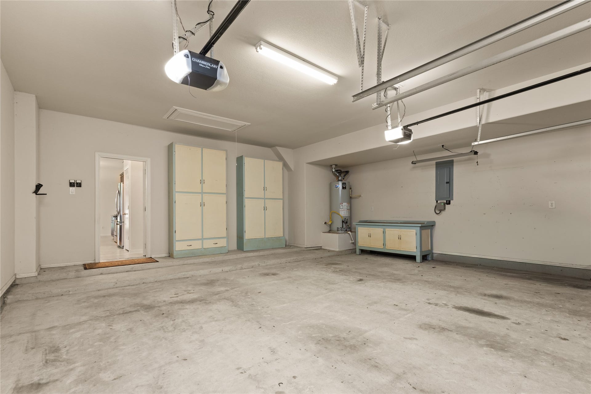 20507 Emery Manor Lane, Porter, TX 77365 Spacious garage with ample storage cabinets, overhead lighting, and direct access to the interior of the home.