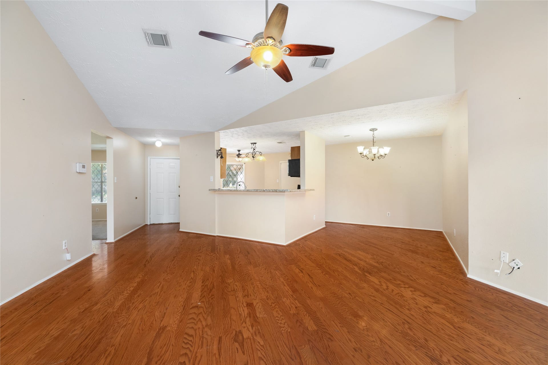 Standing in living area, looking at dining room and kitchen