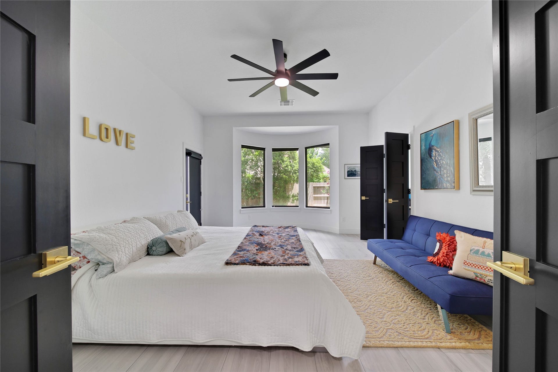 142 Pronghorn Place, Montgomery, TX 77316 Primary Bedroom. Large windows with blackout shades and an exterior door to back patio. Plenty of room for a sitting area and additional furniture.
