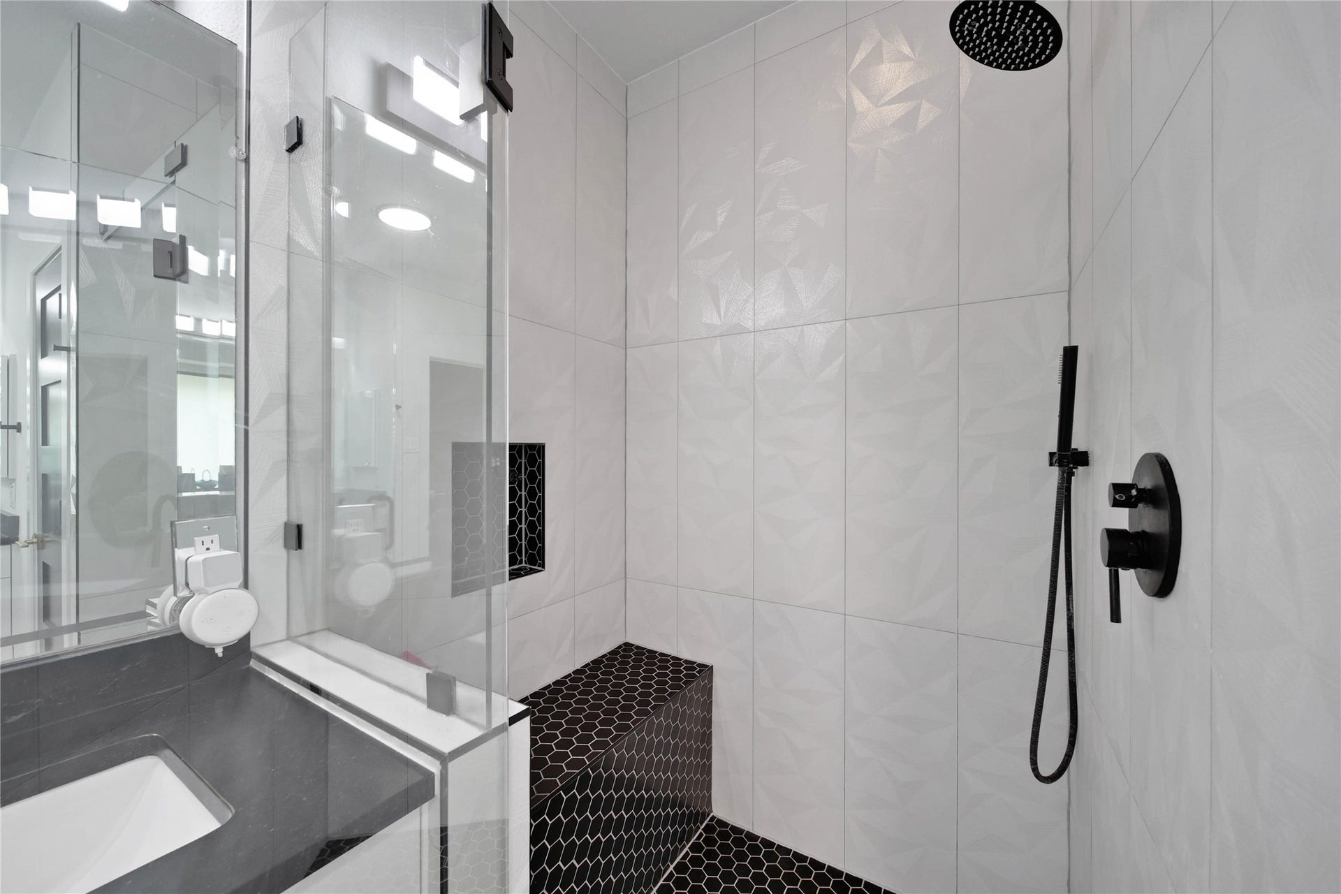 142 Pronghorn Place, Montgomery, TX 77316 Primary Bathroom separate shower. Modern, walk-in shower with a glass door. The space includes a built-in bench and product cutout.