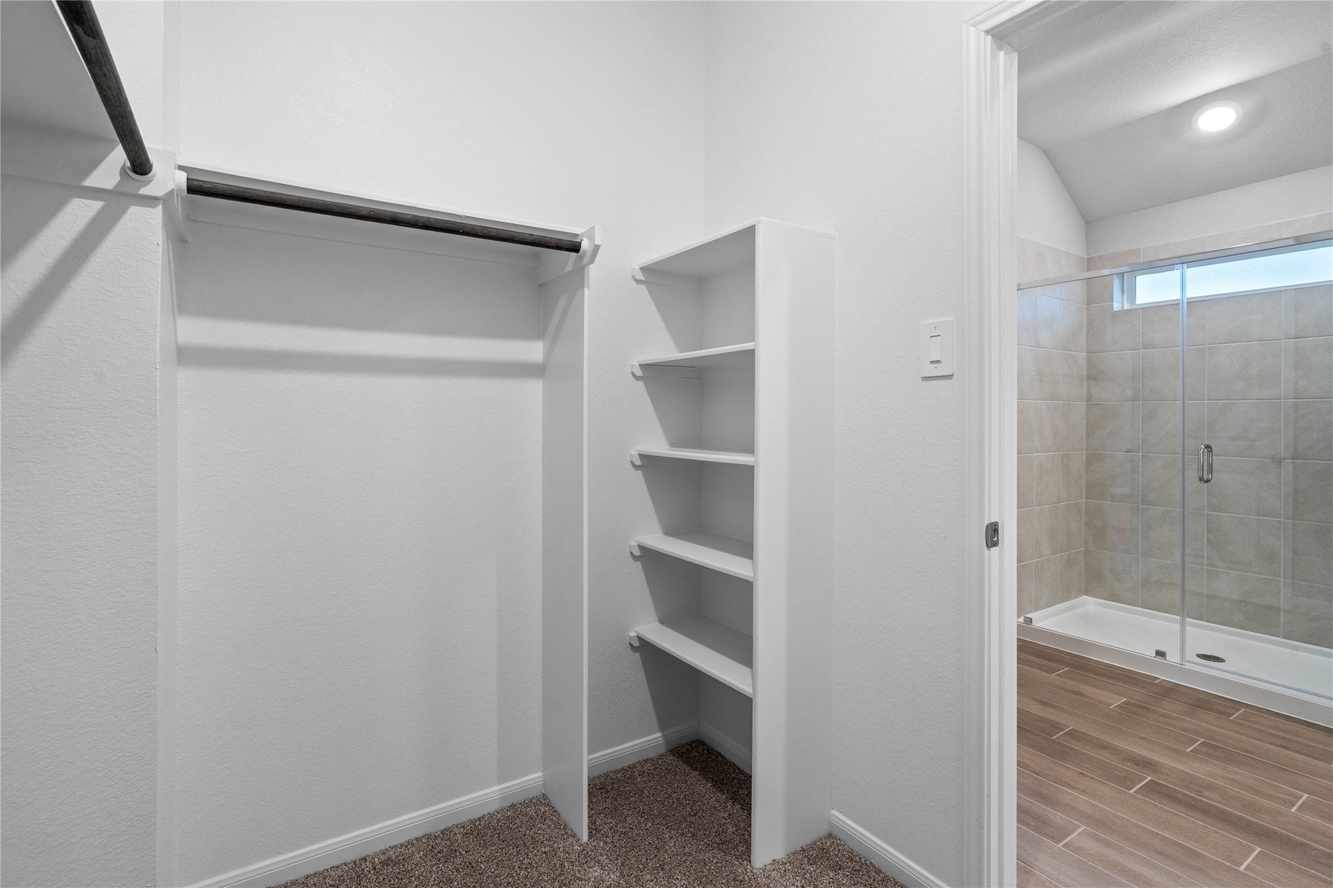 19560 Stripe Hill Bend, Montgomery, TX 77316 The primary suite features a generous walk-in closet equipped with functional hanging rods and shelving.