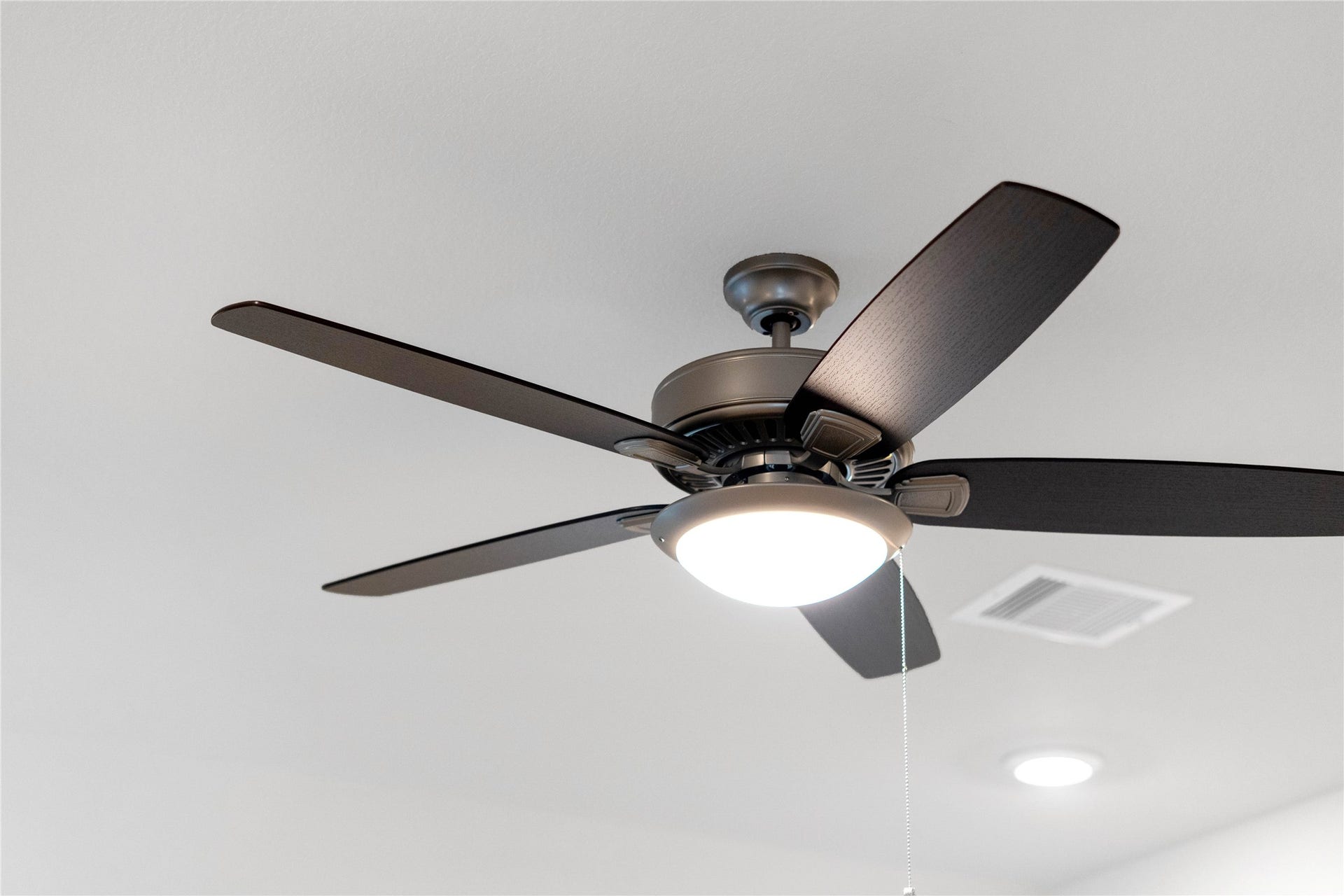 19560 Stripe Hill Bend, Montgomery, TX 77316 This contemporary ceiling fan features a brushed nickel finish and five dark wood blades, centered by an integrated LED light kit and a traditional pull chain for effortless control. The ceiling fan will make a room feel up to 48 degrees cooler and redistribute rising warm air in the winter.