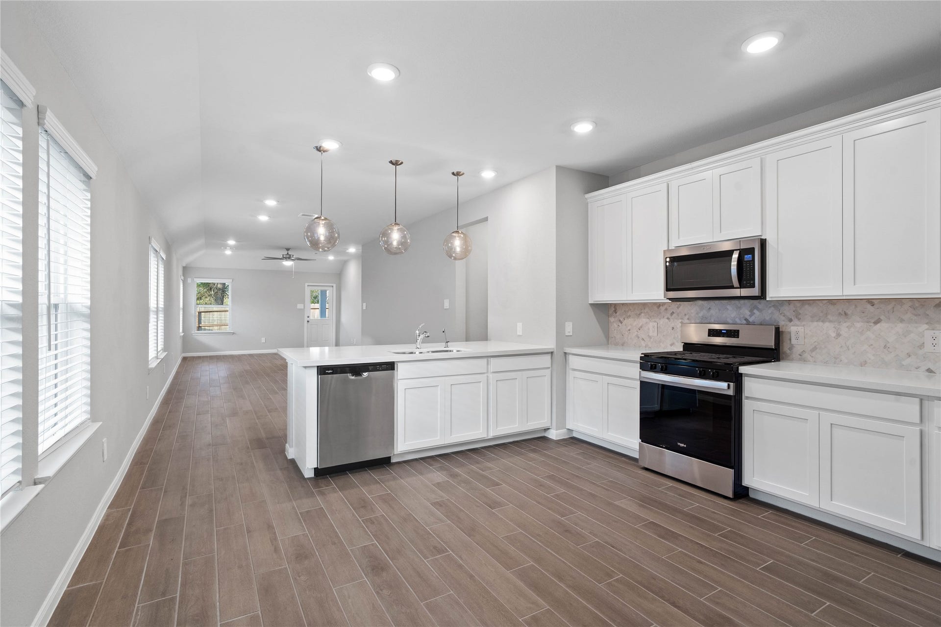 19560 Stripe Hill Bend, Montgomery, TX 77316 From the expansive kitchen, enjoy seamless sightlines across the open-concept living and dining areas, making entertaining a breeze and ensuring you're never far from the conversation.