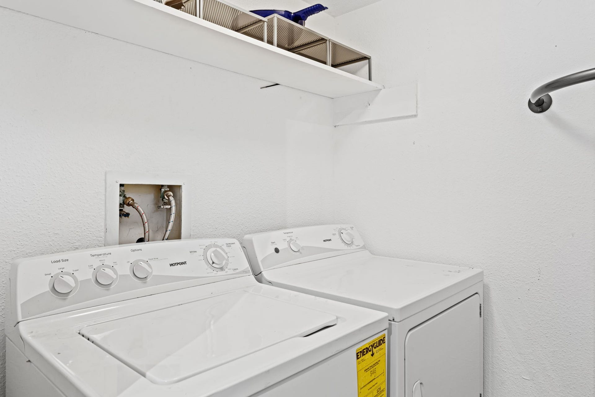 2211 S Kirkwood Road, #1, Houston, TX 77077 The dedicated first-floor utility room houses a full-size side-by-side washer and dryer not stacked, not tucked behind a bifold door in the hallway. An overhead shelf adds storage above, and the setup is contained in its own room entirely separate from the living spaces.