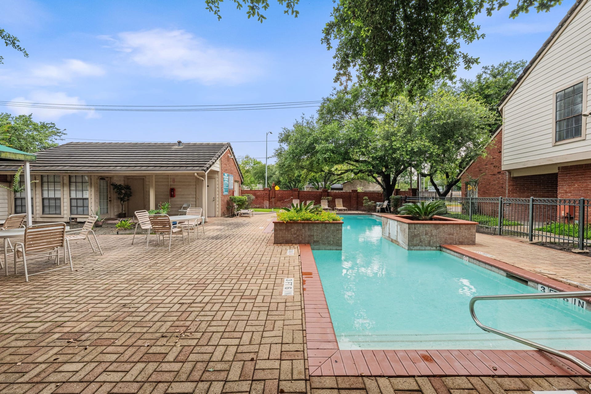 2211 S Kirkwood Road, #1, Houston, TX 77077 The community pool is directly adjacent to Unit 1 a well-maintained rectangular pool set within a generous brick paver surround. It's the kind of amenity that actually gets used.