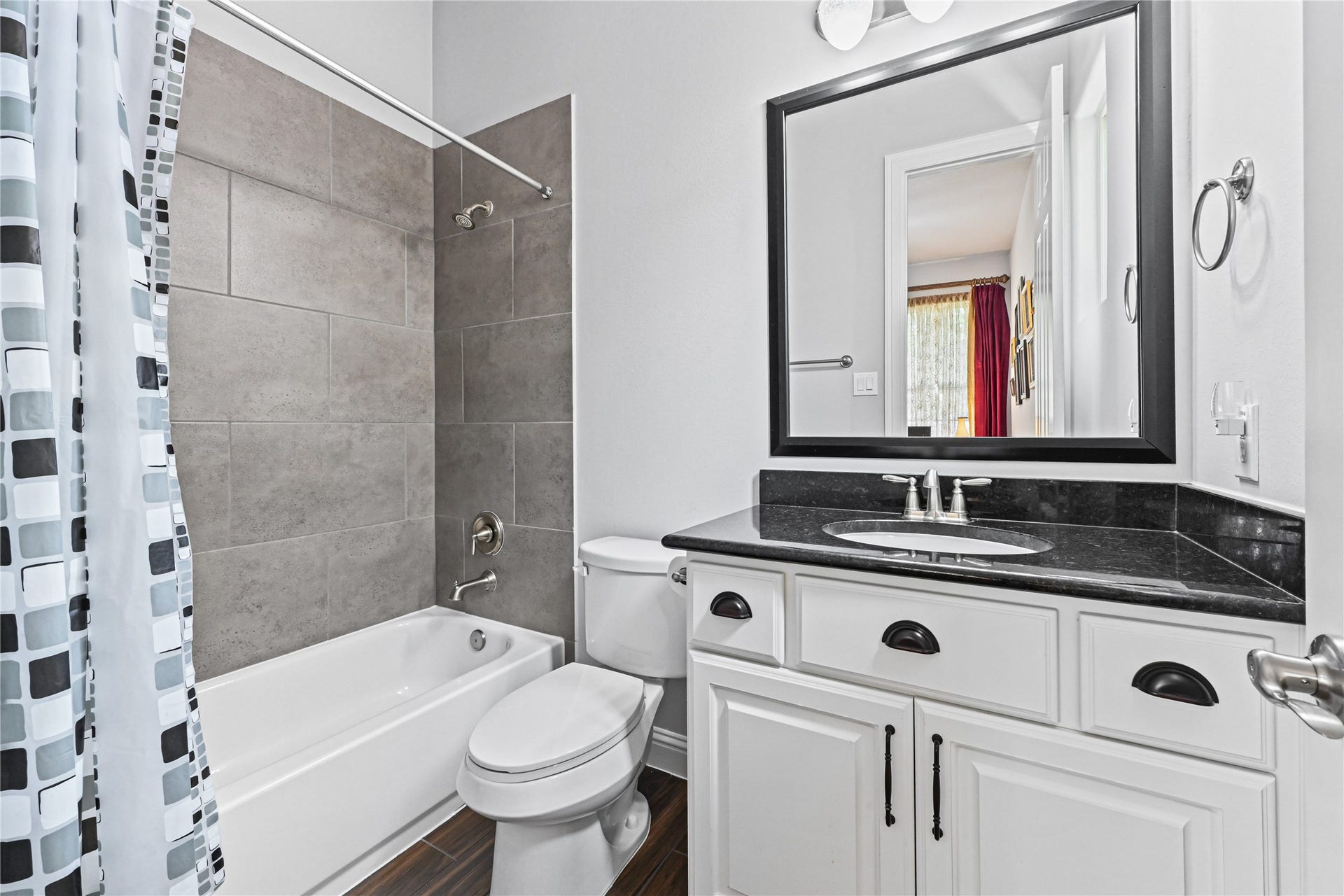 The private Guest Suite bathroom is beautifully appointed with a spacious vanity offering plenty of drawer storage, gorgeous granite countertops & matching granite backsplash, deep undermount sink, stylish fixtures and a tub/shower combinationperfect for making your guests feel right at home!