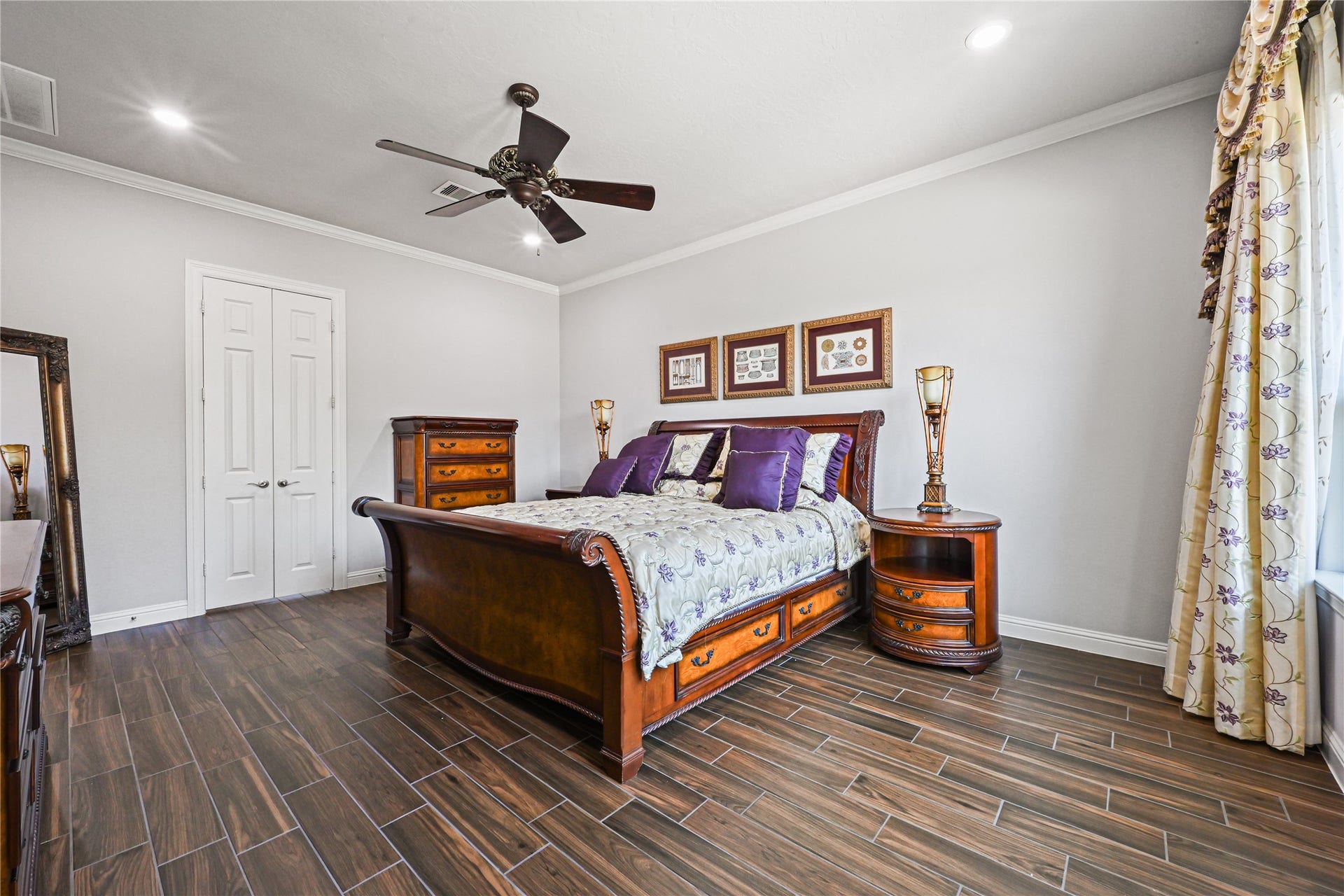 The stunning primary suite boasts dramatic high ceilings beautifully accented with elegant crown molding, creating a luxurious and relaxing retreat! French doors open to the impressive spa-inspired primary bathroom, thoughtfully designed for two. Your own private escape awaits at the end of every day!