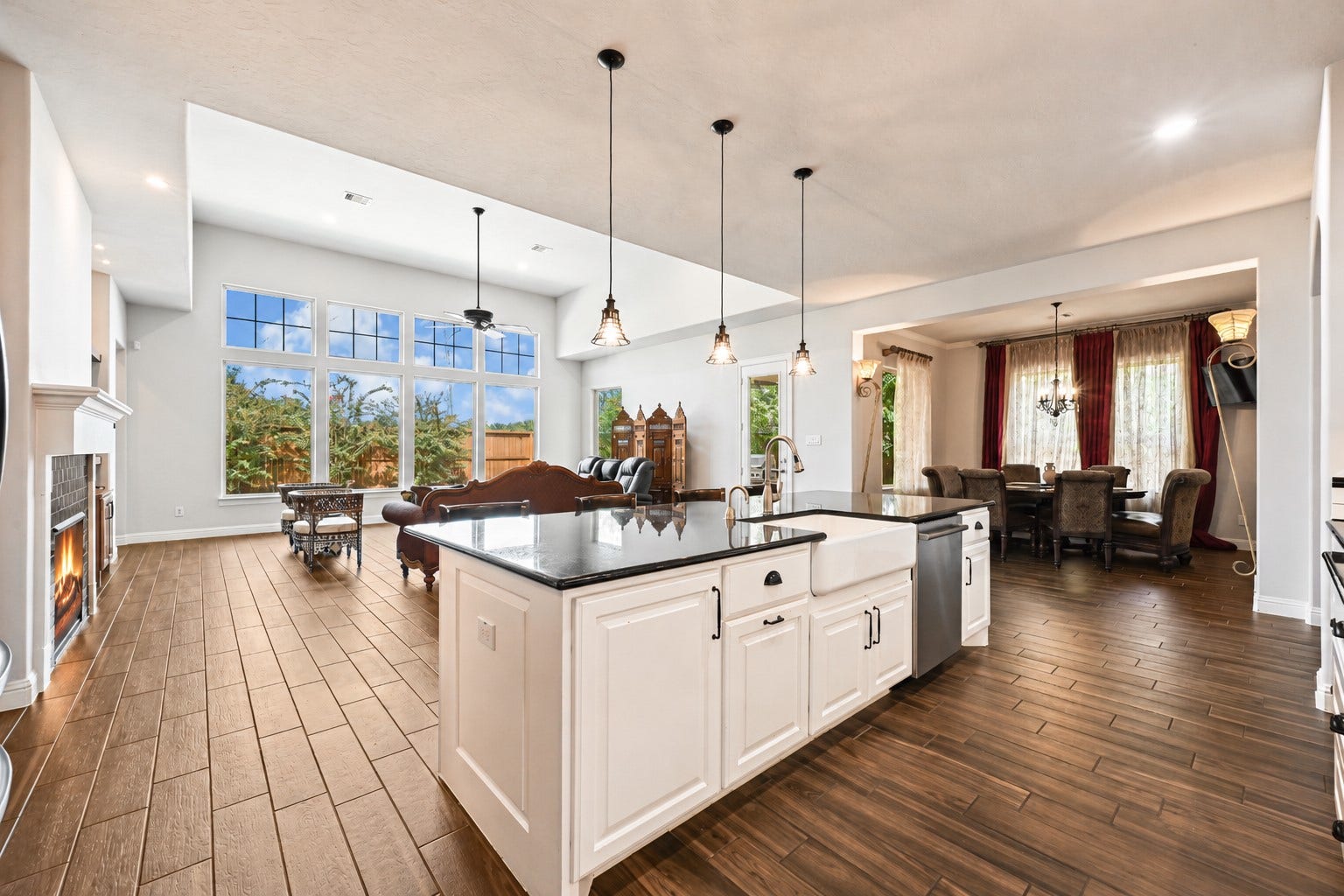 WOW! The massive eat-in working island is the centerpiece of this gourmet kitchen, featuring gorgeous granite countertops with upgraded bullnose edges & stunning pendant lighting that makes the entire space shine! The kitchen flows effortlessly into the casual dining area and dramatic family room, creating an incredible open-concept design. Walls of windows showcase your private backyard with no rear neighbors while filling the home with beautiful natural light. Custom details, amazing views & an open desig