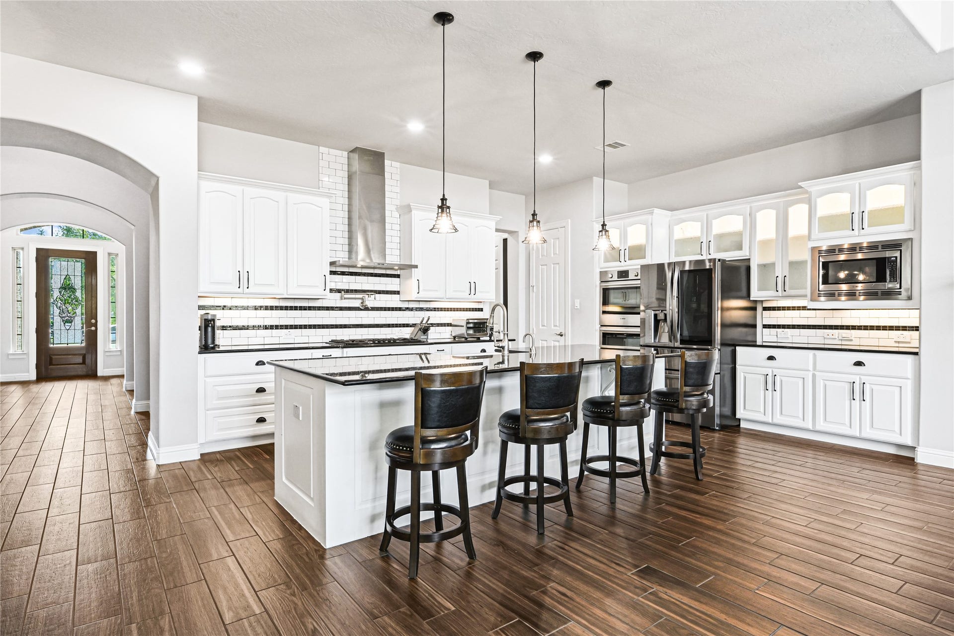 Want to know what a true custom gourmet kitchen looks like? Well, here it is! Stunning tall custom cabinetry, under-cabinet lighting, oversized pots & pans drawers, a powerful custom vent hood, convenient pot filler & so much more! Every detail was thoughtfully designed for beauty, function & entertainingthis is a kitchen that truly delivers the WOW factor!