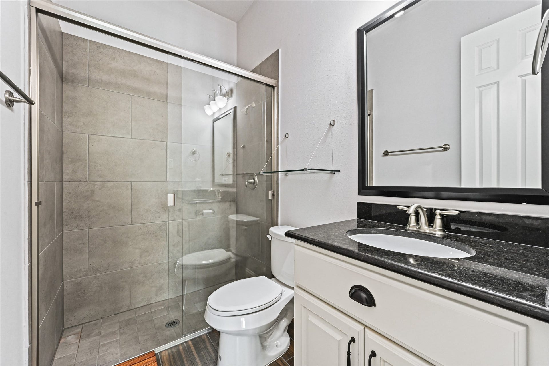 Yes, another beautiful full guest bathroom! Enjoy the extra-large walk-in shower featuring a seamless sliding glass door, stunning custom tile surround & tile flooring. Quality finishes and thoughtful details throughoutthis custom-built home was designed with style, comfort & lasting beauty in mind!