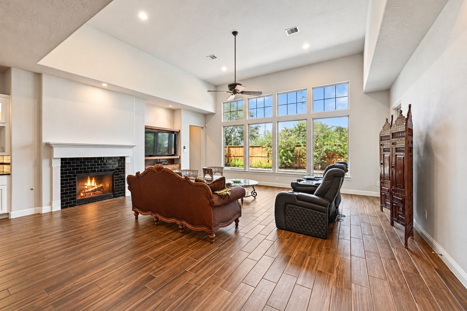 Dramatic high ceilings create an incredible sense of space, while the impressive custom fireplace adds warmth, character & a beautiful focal point to this stunning family room. Imagine gathering around the fireplace with family and friends during the upcoming holidayssimply breathtaking!