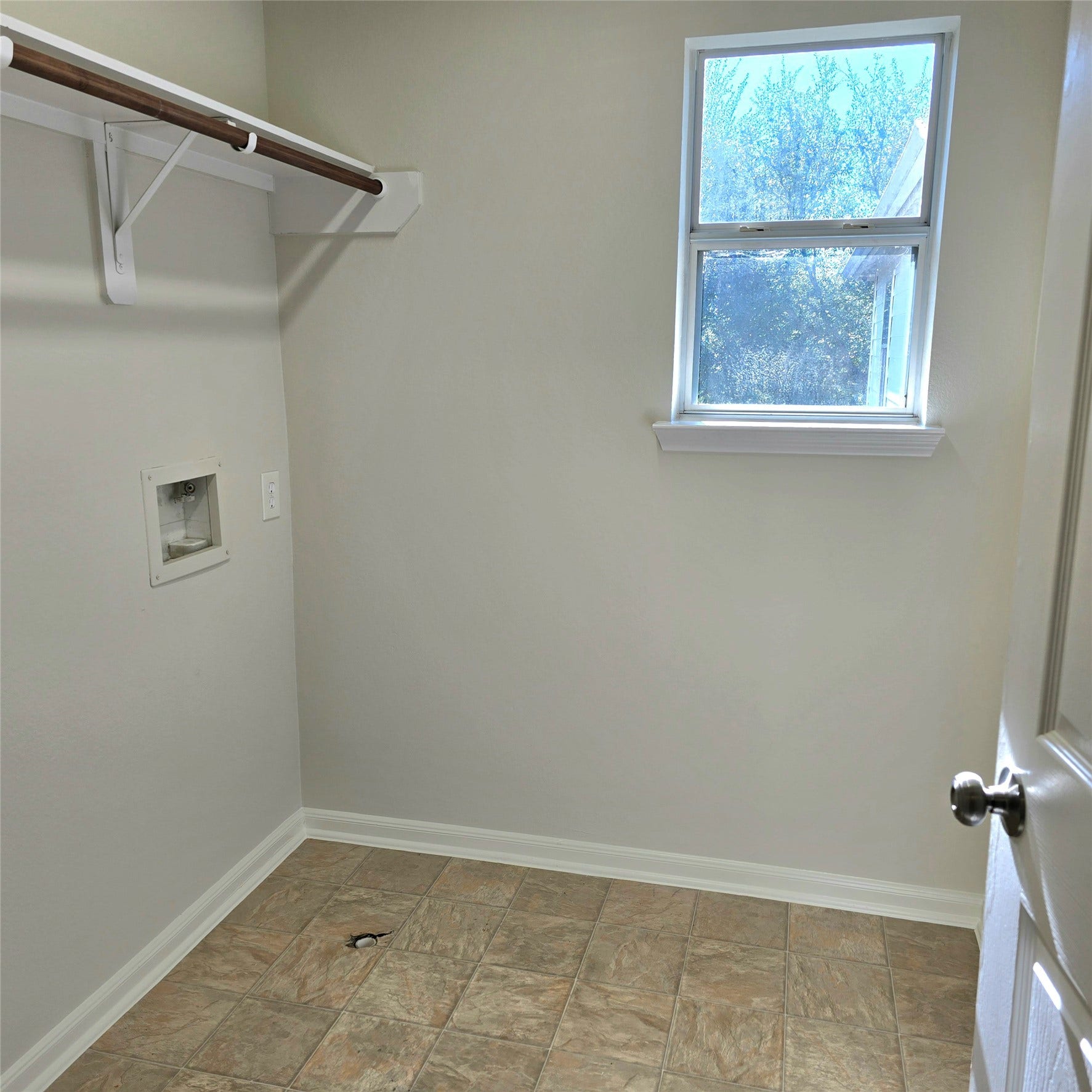 12006 Audubon Hill Court, Houston, TX 77038 Spacious laundry room with shelving.