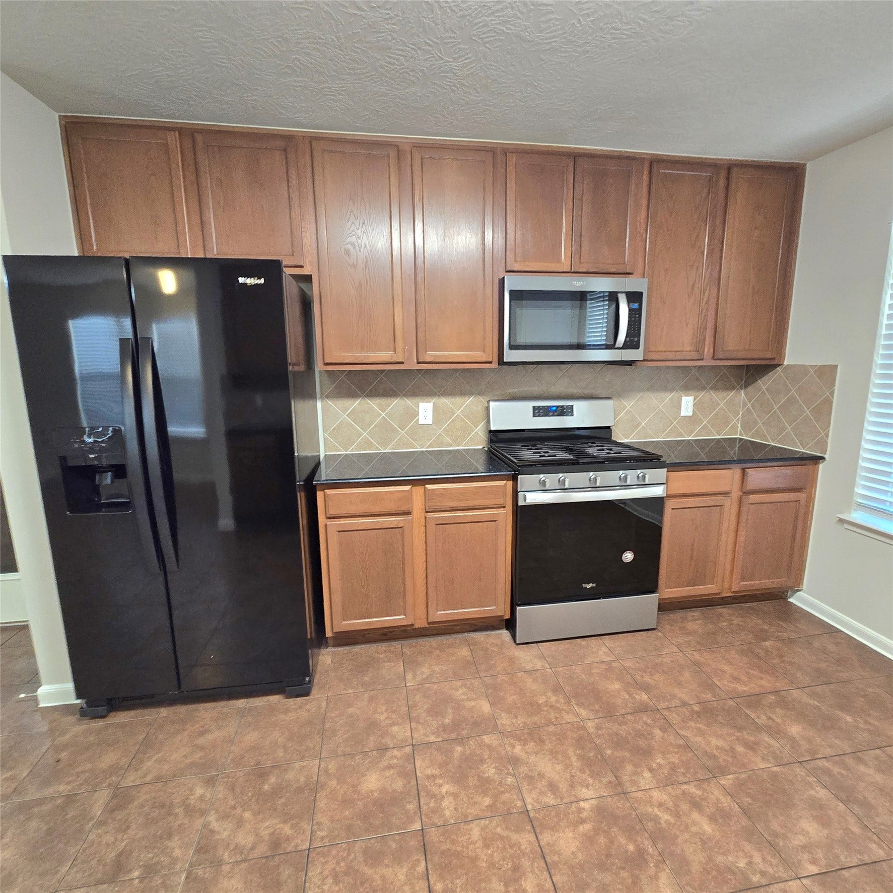 12006 Audubon Hill Court, Houston, TX 77038 Well equipped kitchen, with plenty of cabinets. Tile floors.
