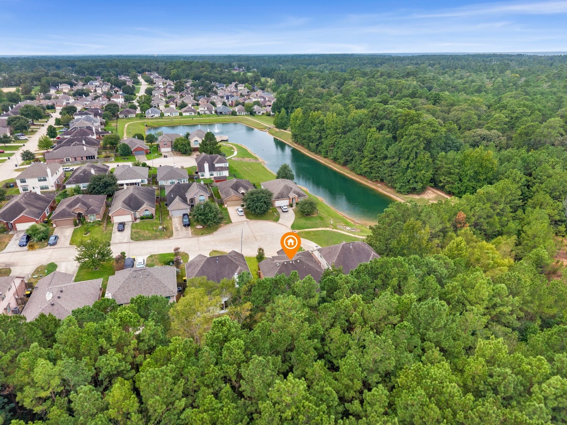 Wide aerial view highlighting the home's premier position backing directly to miles of lush green forest preserve with close proximity to a neighborhood pond and trails.