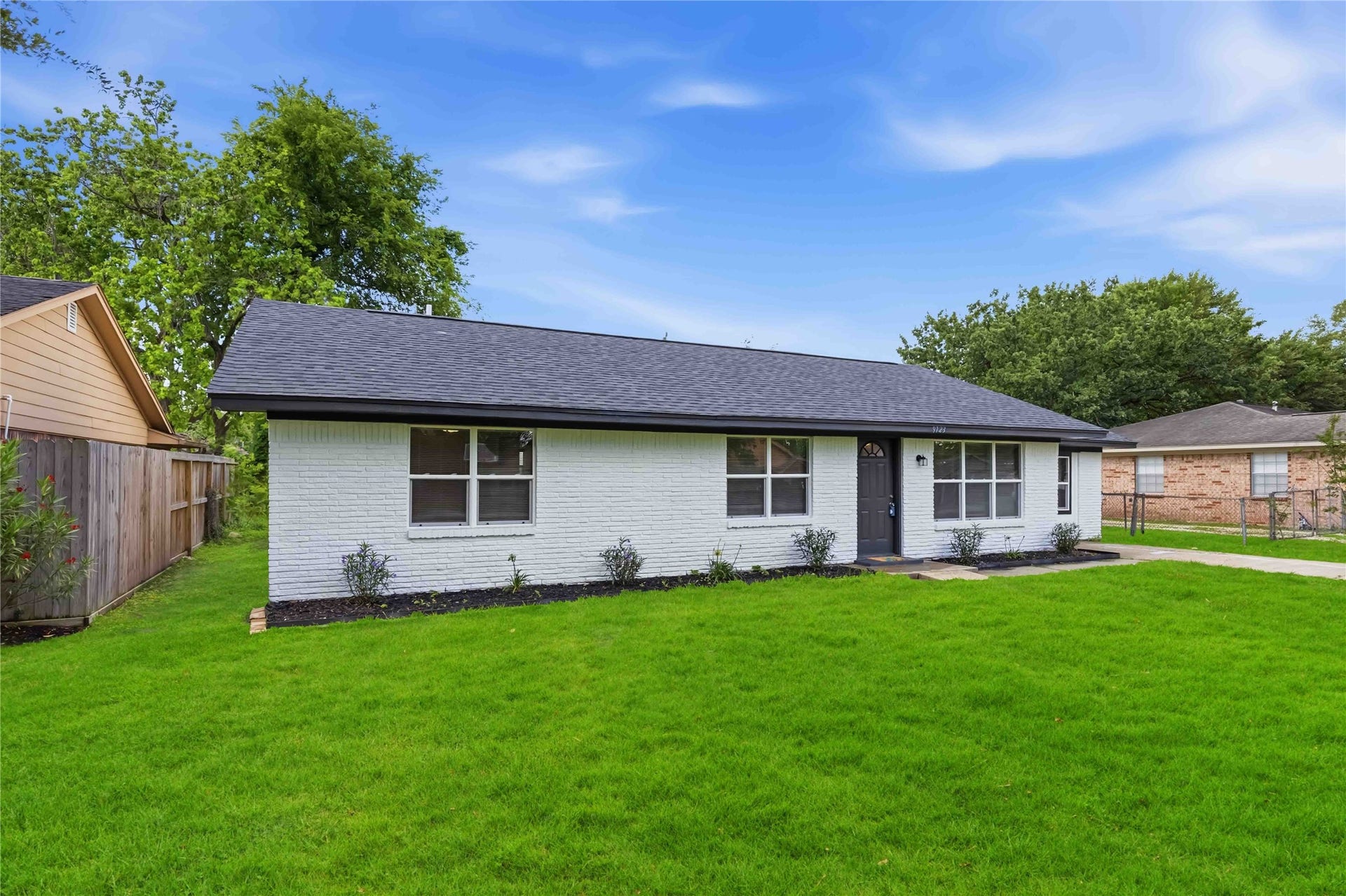 9723 Oldcrest Drive, Stafford, TX 77477 Large front yard and a beautiful front elevation.