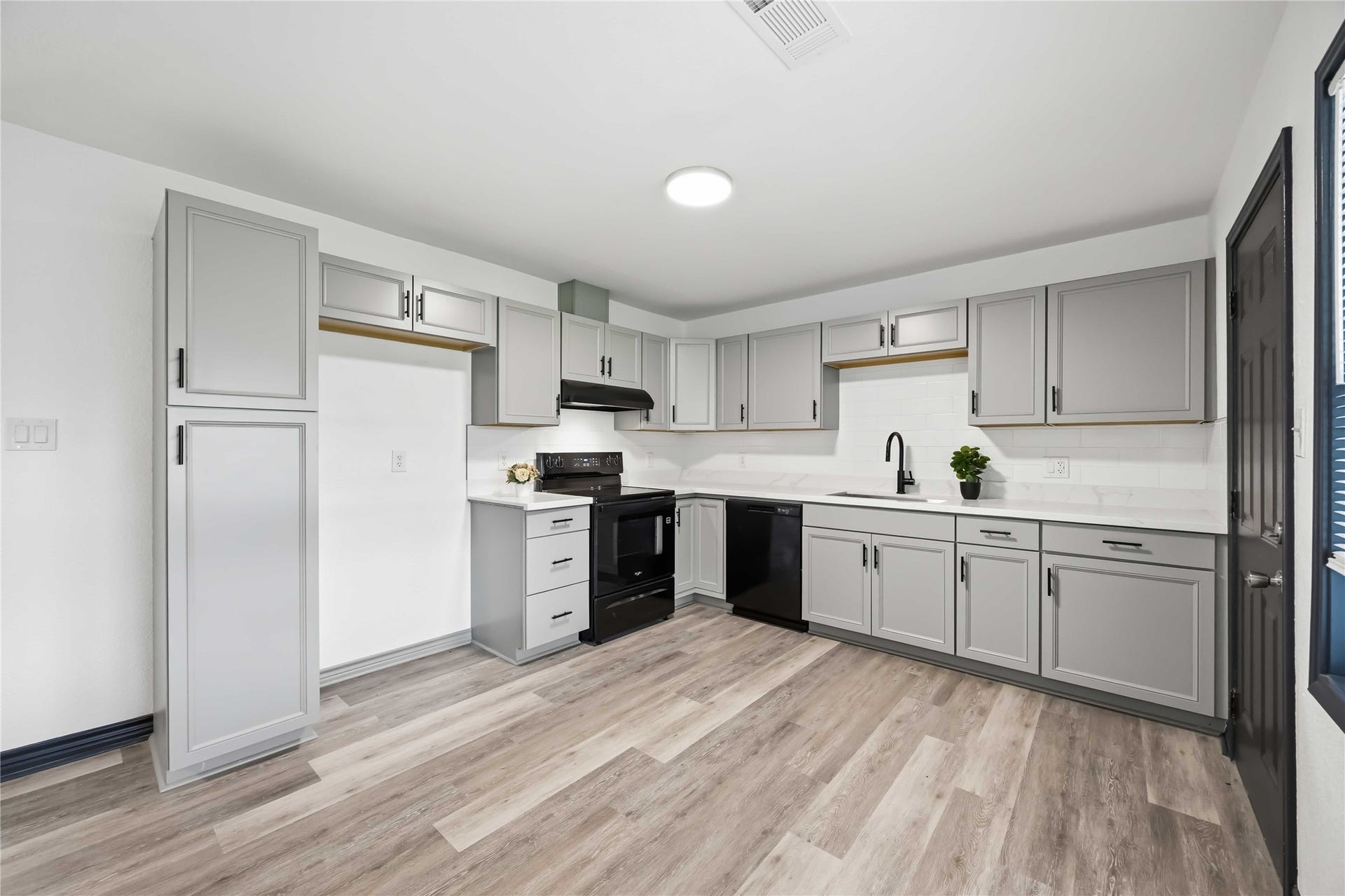 9723 Oldcrest Drive, Stafford, TX 77477 A closer look at this modern kitchen with a stove, dishwasher and an exterior venting vent hood.