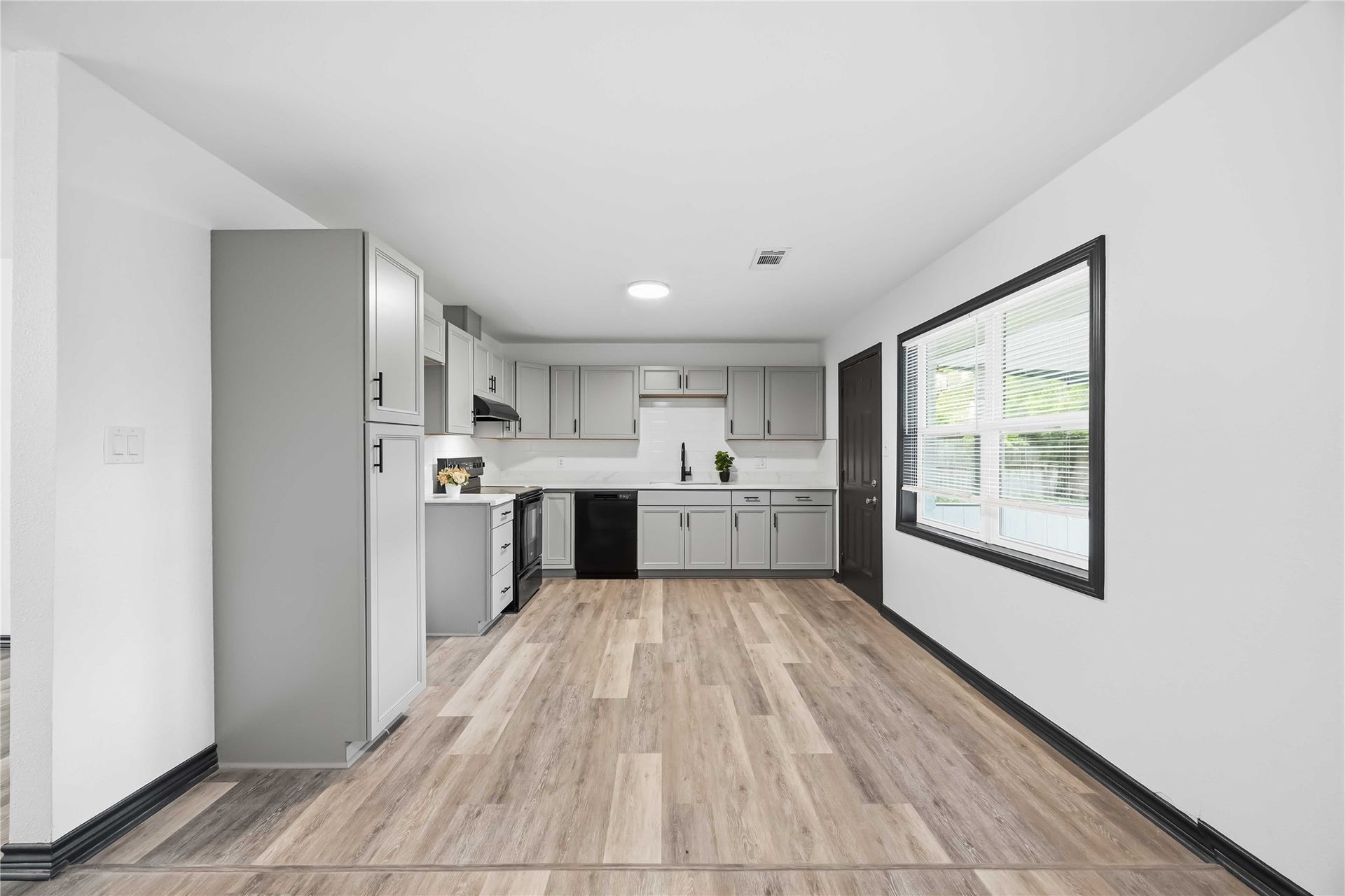 9723 Oldcrest Drive, Stafford, TX 77477 Lovely updated kitchen with plenty of storage. Black door leads to the spacious backyard.