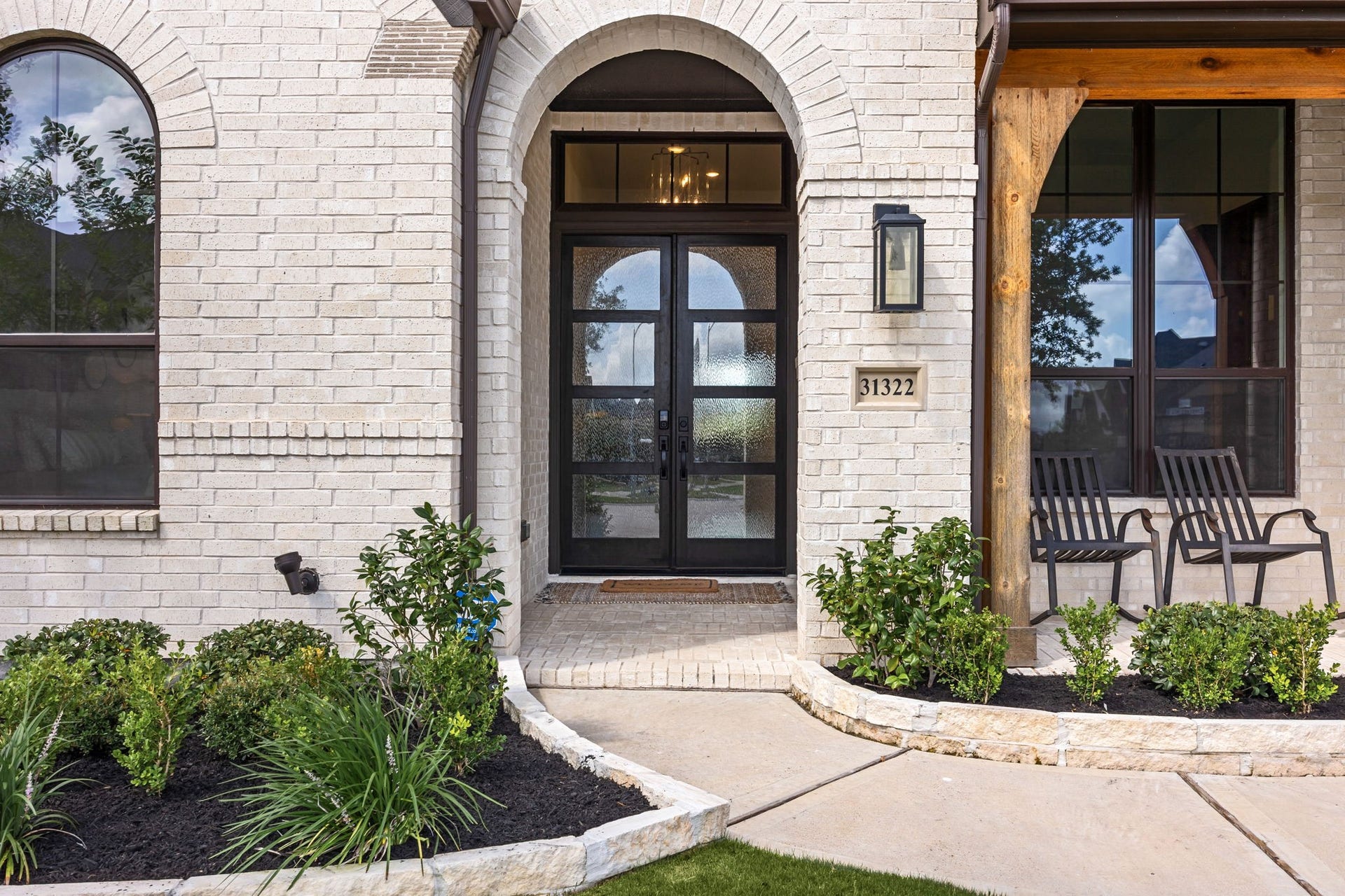 31322 Crescent Hill Drive, Fulshear, TX 77441 Step inside and feel right at home. This stunning arched entryway welcomes you with warm wood accents, beautiful double glass doors, and a charming front porch made for morning and evening relaxation.