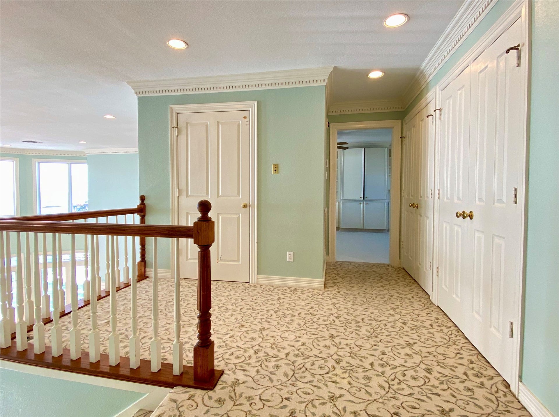 919 Long Reach Drive, Tiki Island, TX 77554 The landing at the top of the stairs with tons of storage space in the two closets. Door on left is the elevator.
