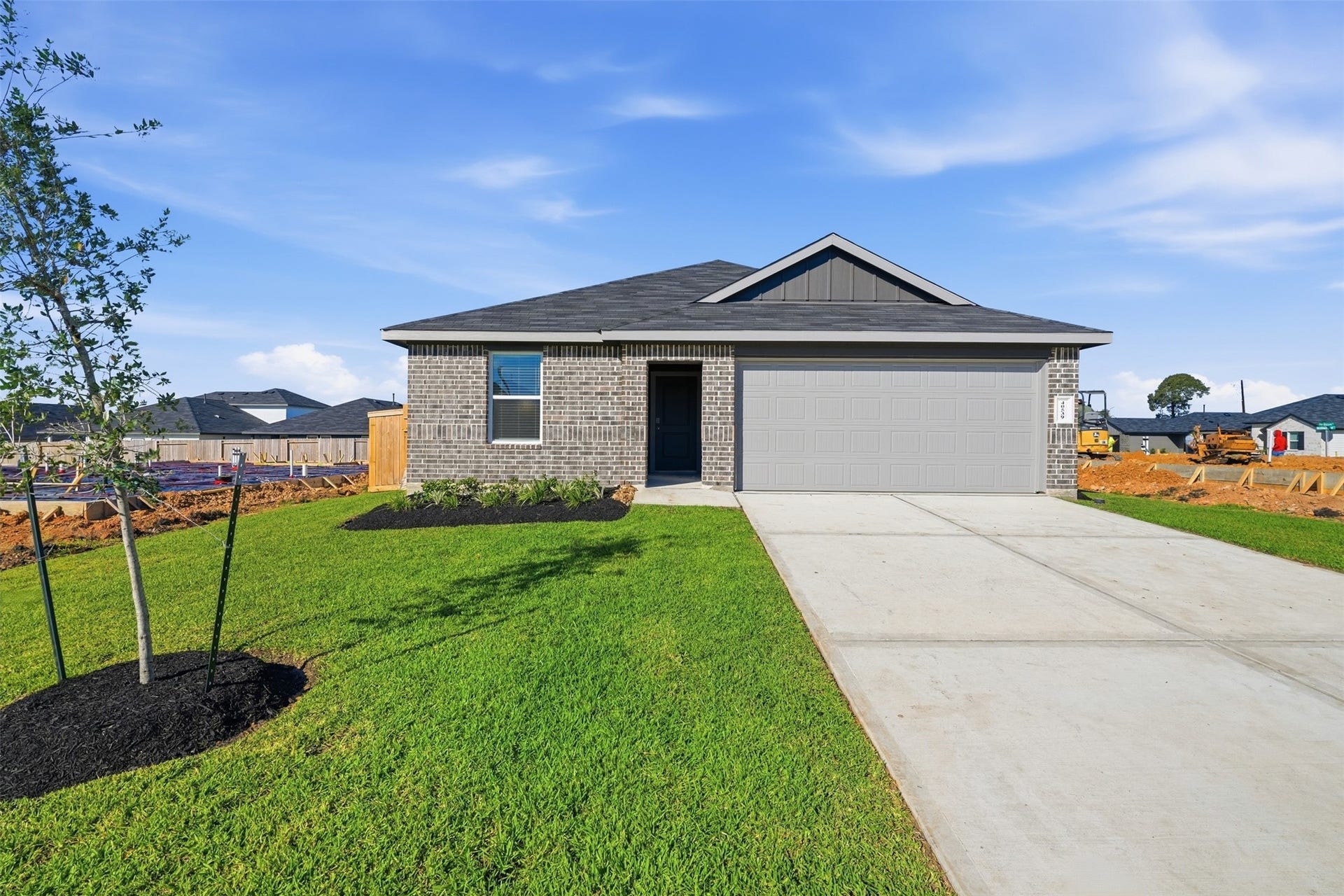Charming modern home with a sleek brick exterior, two car garage.