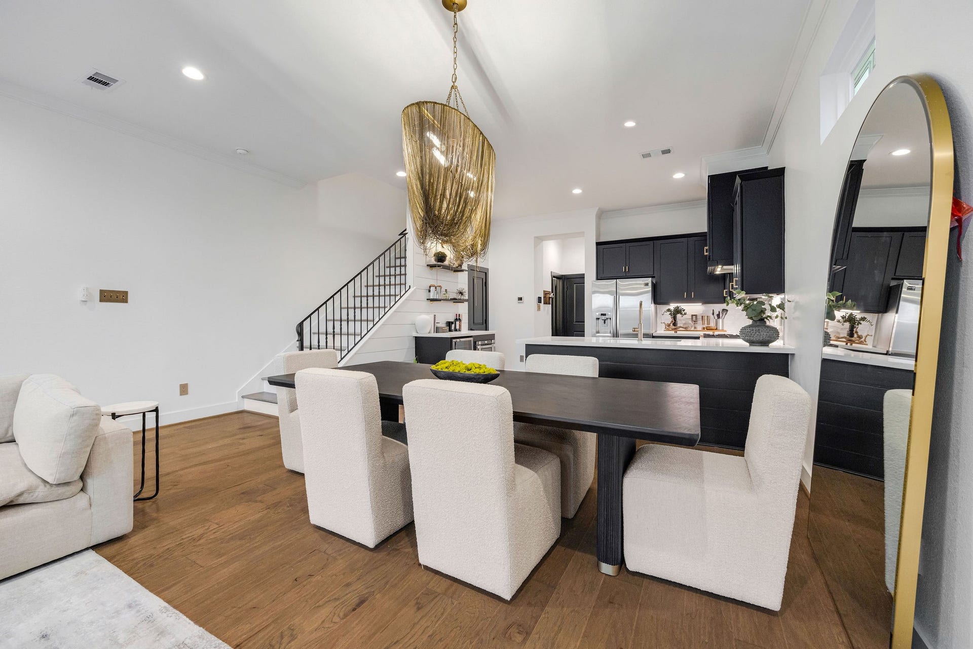 5537 Petty Street, Houston, TX 77007 Elegant open-concept dining area with modern lighting, sleek dark cabinetry, and a spacious kitchen complete with stainless steel appliances.