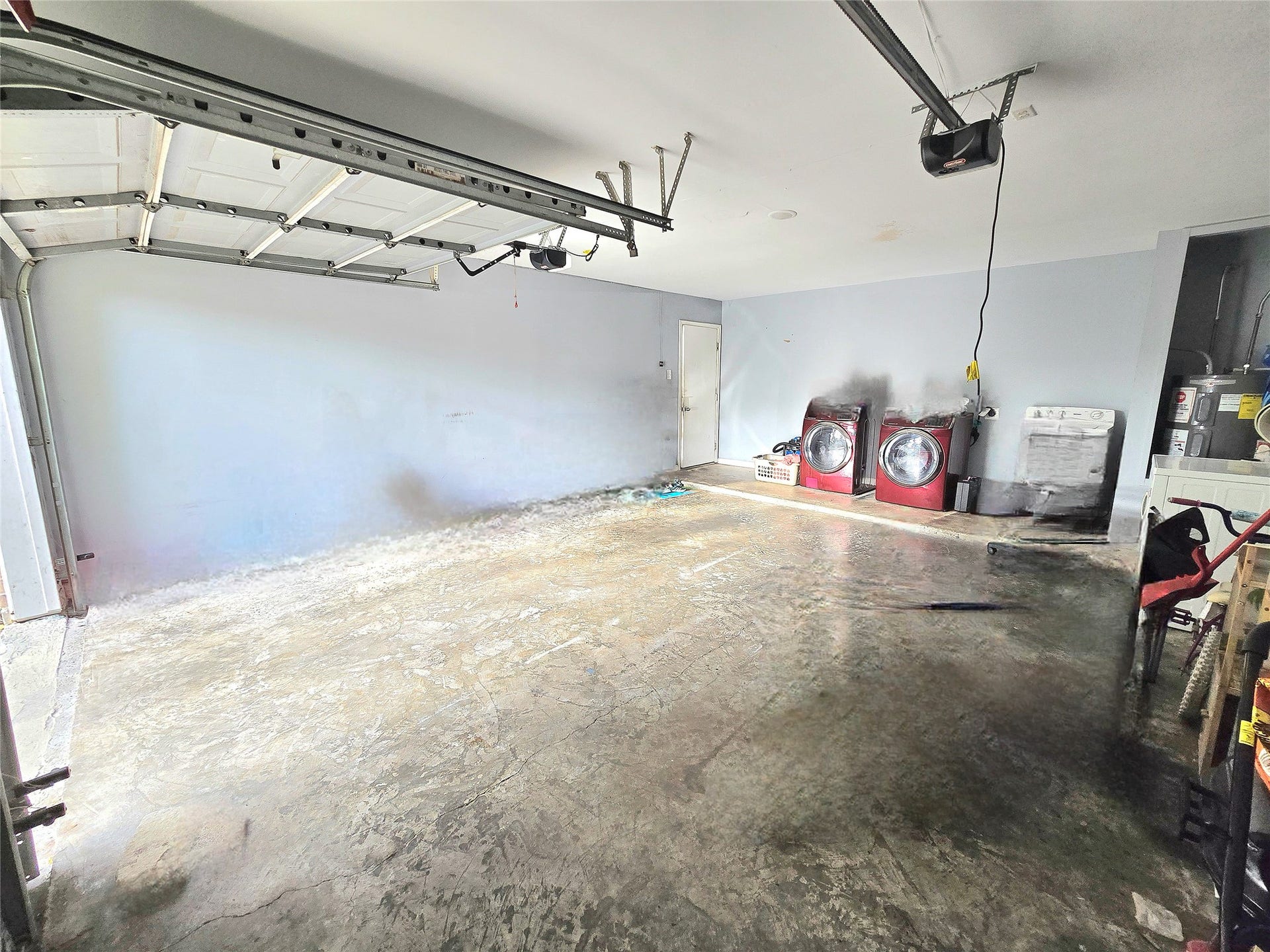 5205 Winding Brook Drive, Dickinson, TX 77539 Spacious garage with ample storage space, featuring washer and dryer hookups for convenient laundry access.