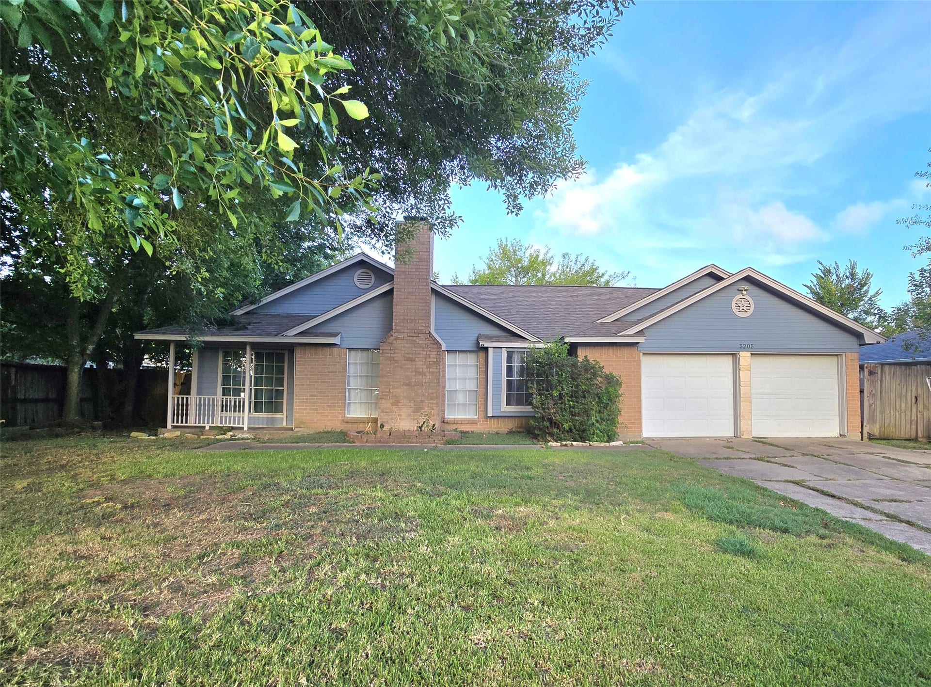 5205 Winding Brook Drive, Dickinson, TX 77539 Charming single-story home with a welcoming front porch, spacious driveway, and dual garage. Surrounded by mature trees, this property offers a serene setting.