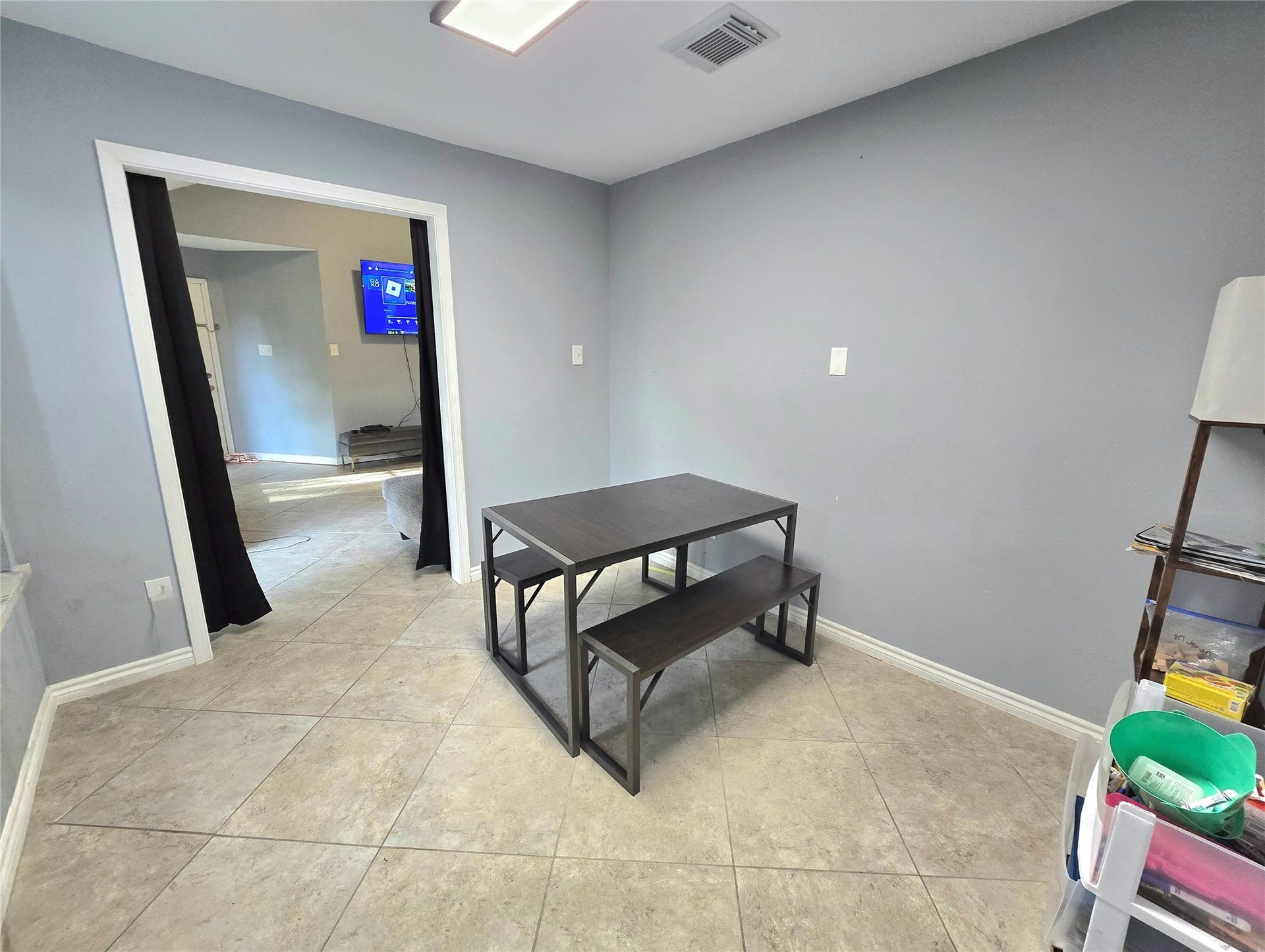5205 Winding Brook Drive, Dickinson, TX 77539 Bright and inviting room with sleek tile flooring, featuring a cozy dining area and a view into an adjoining space, perfect for gatherings.